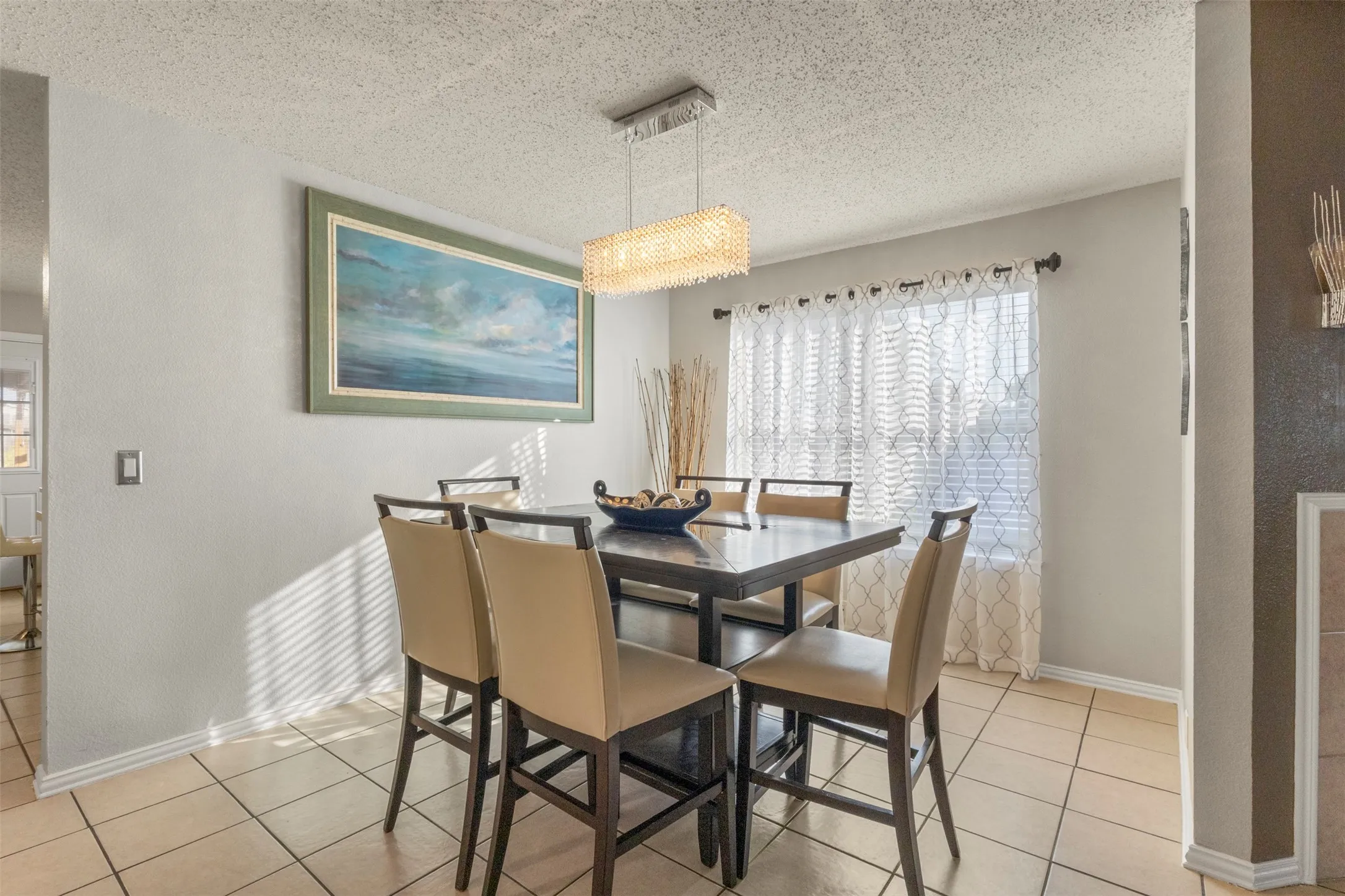 Recessed lighting fixture, tiled flooring, window with natural light, and light-toned wall paint
