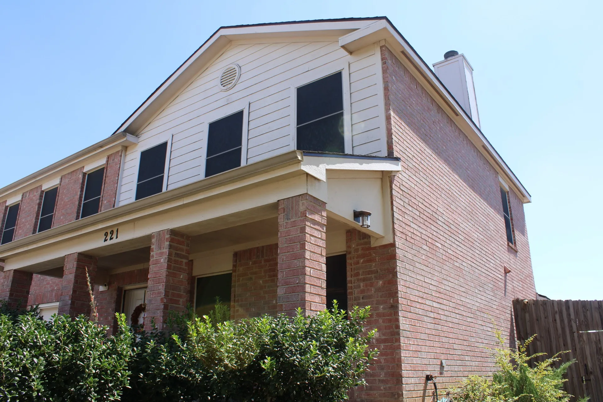 Brick and siding exterior with a covered porch