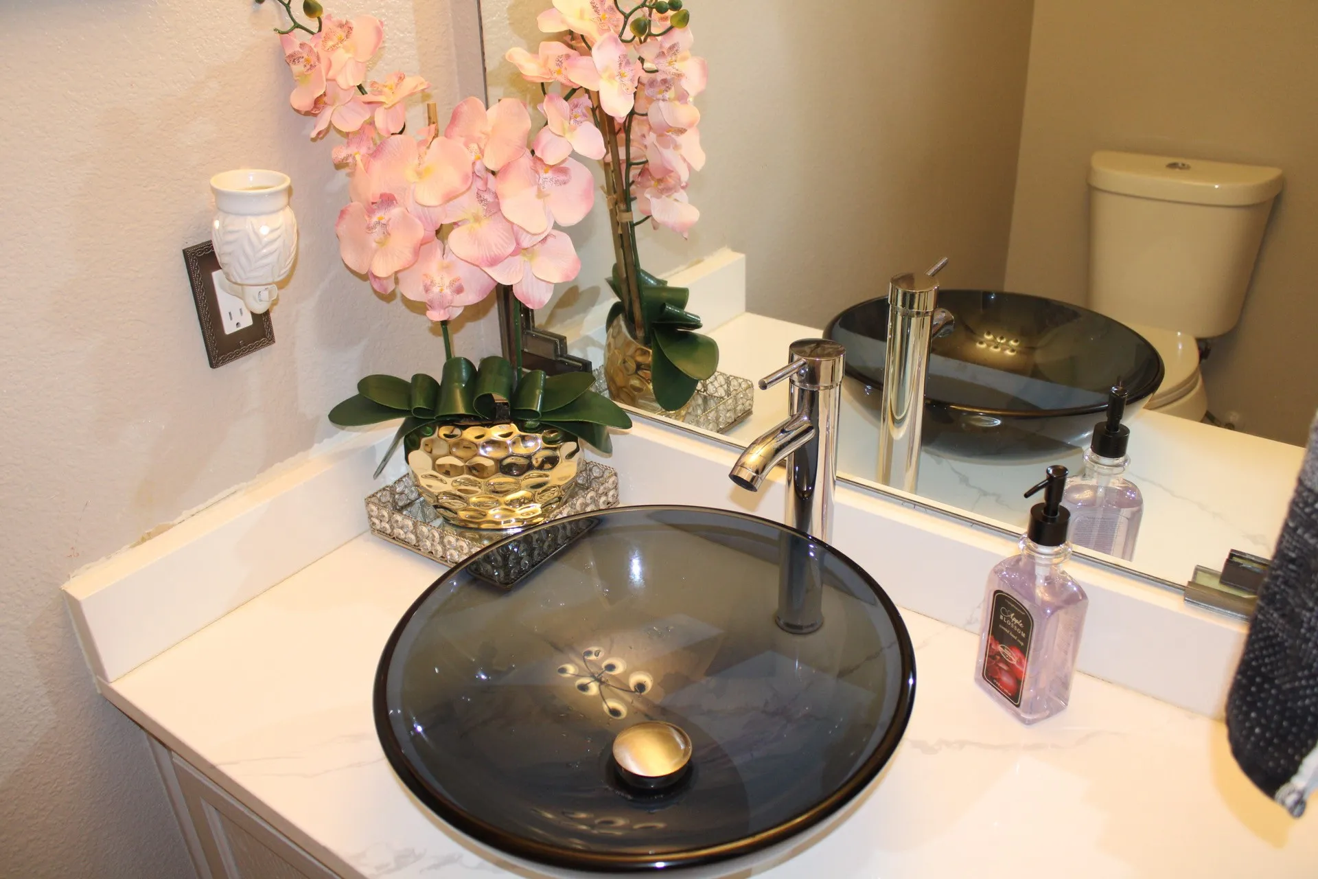 Vanity with a vessel sink, single-handle faucet, and white countertop