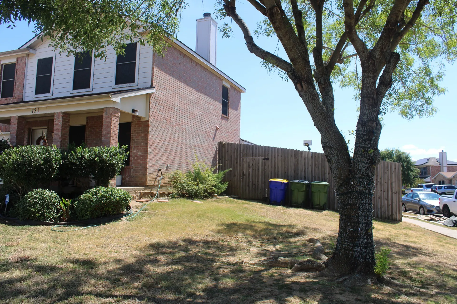 Brick and siding exterior with a covered front porch featuring brick columns