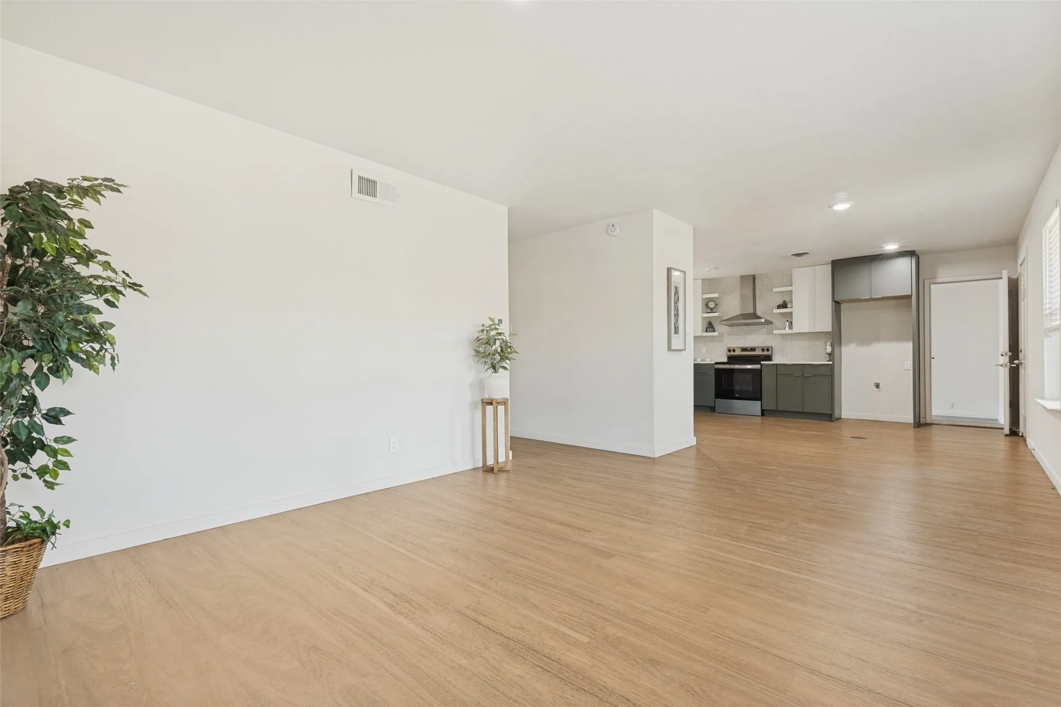 Open-concept living space with wood-finish flooring