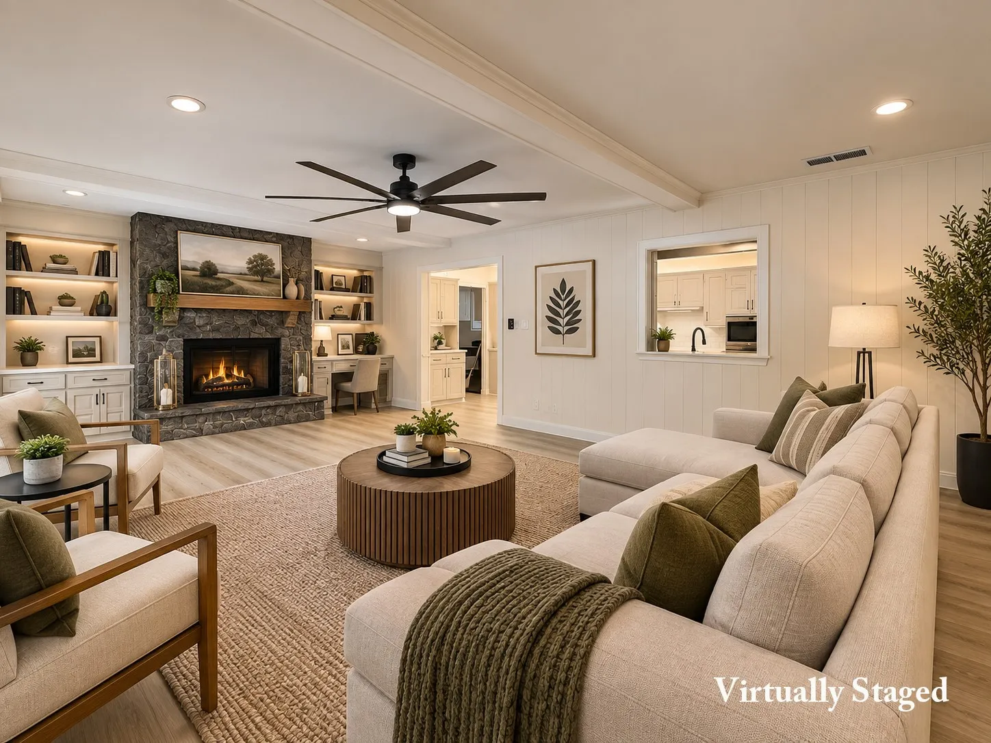 Stone-clad fireplace with wood mantel, built-in shelving with integrated lighting, wood-finish flooring, ceiling fan, and shiplap wall paneling