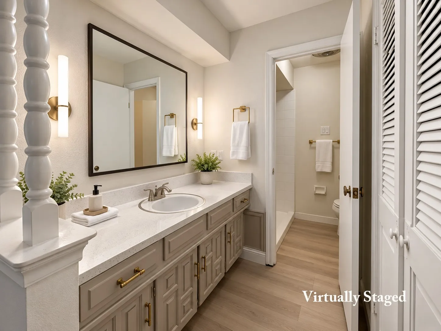 White countertop vanity with dual sinks, gold-tone hardware, a large rectangular mirror, and sconce lighting