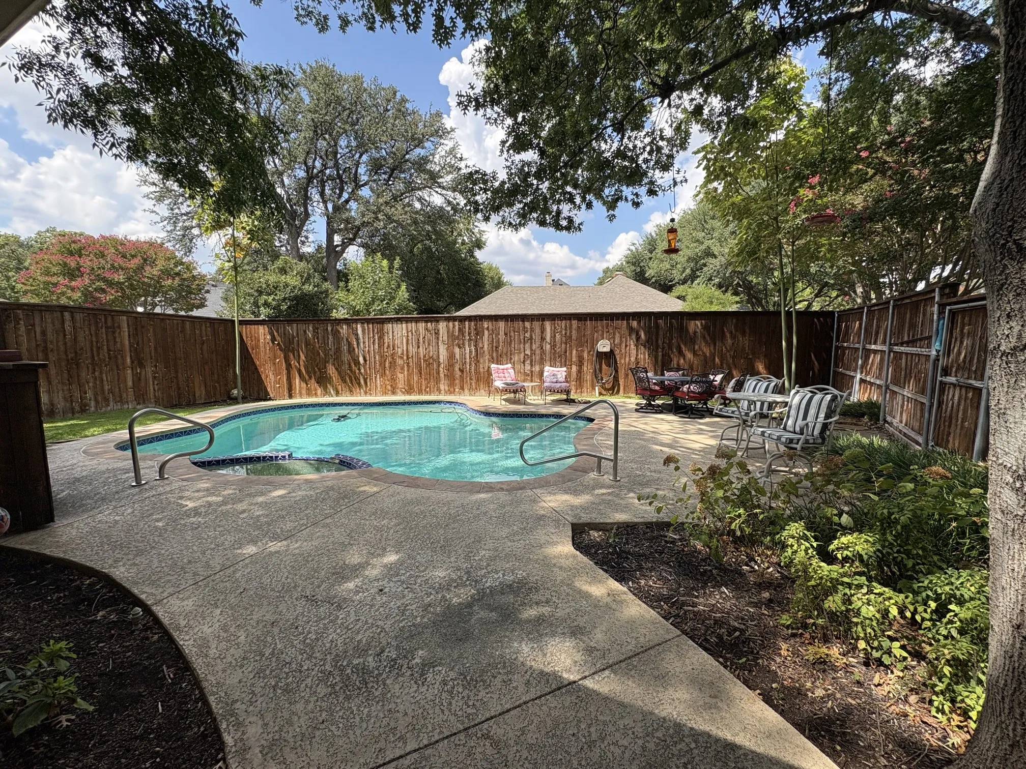 One of two backyard spaces. Beautiful and peaceful pool/spa combo with tall fence for extra privacy.