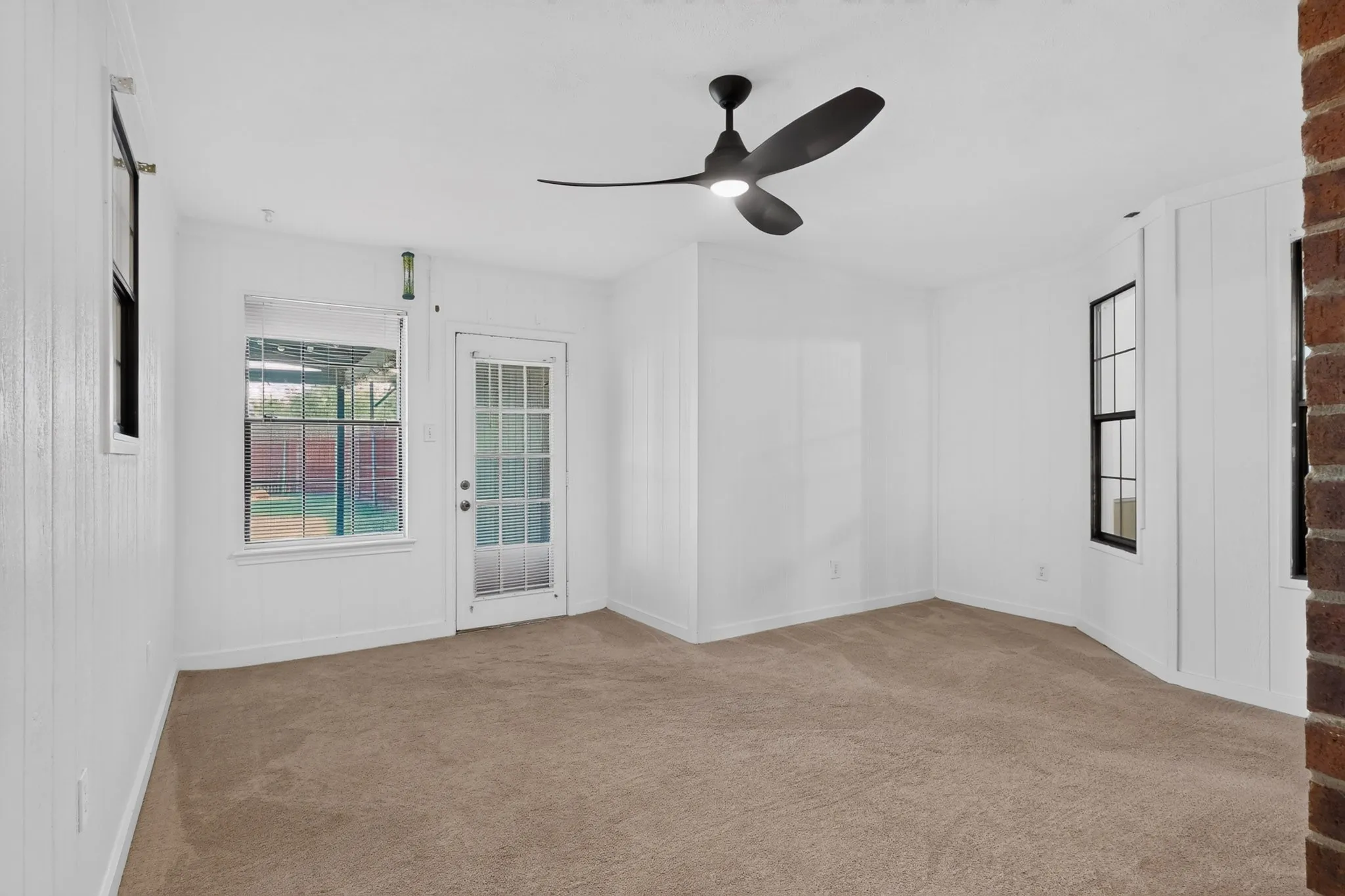 Neutral carpet flooring with white vertical paneling