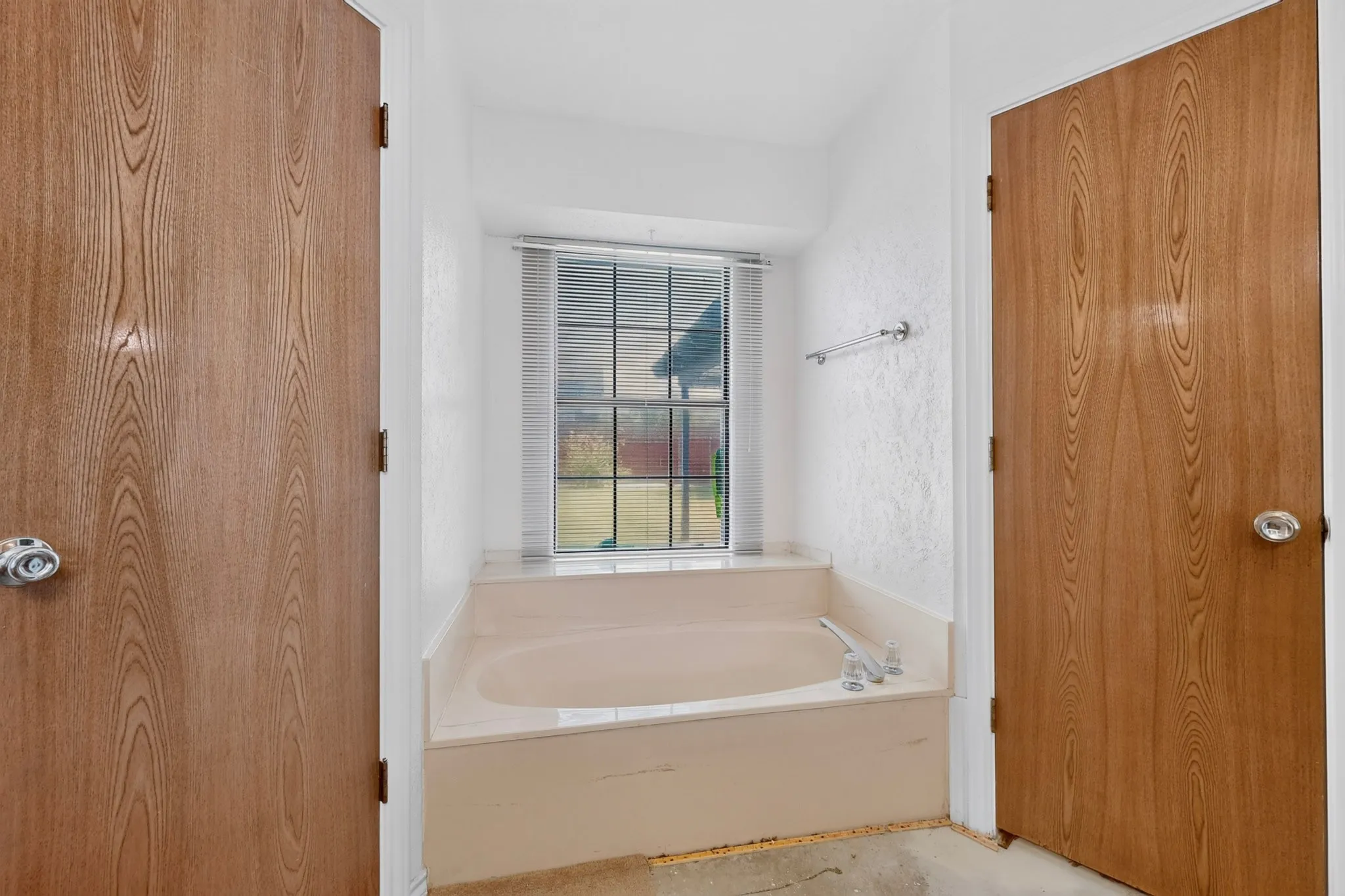 Built-in bathtub with tiled surround and window