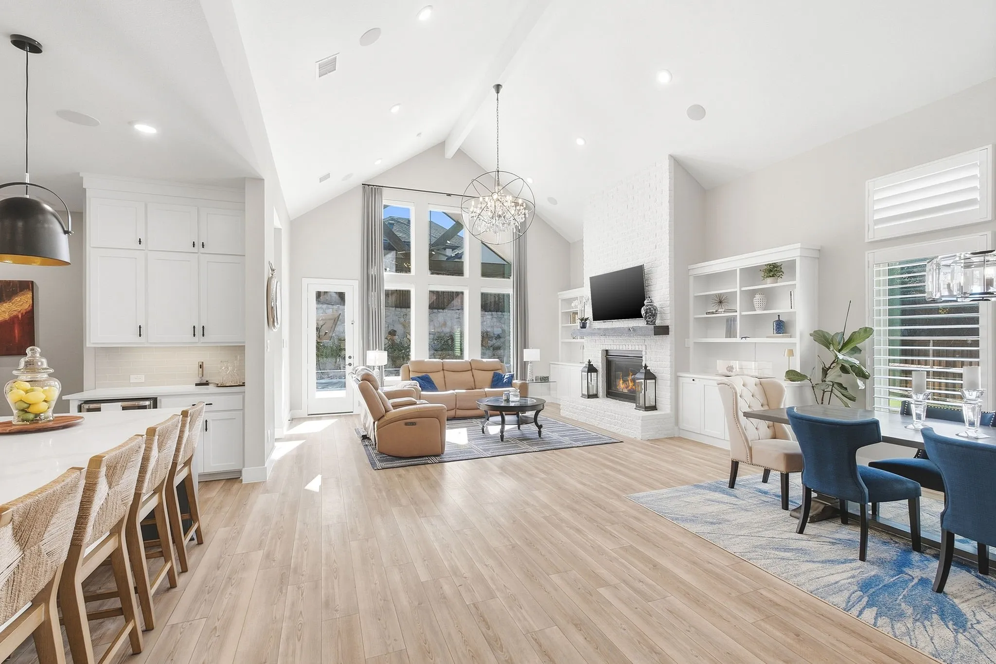 Gourmet kitchen with a large center island, white cabinetry, and stainless steel appliances