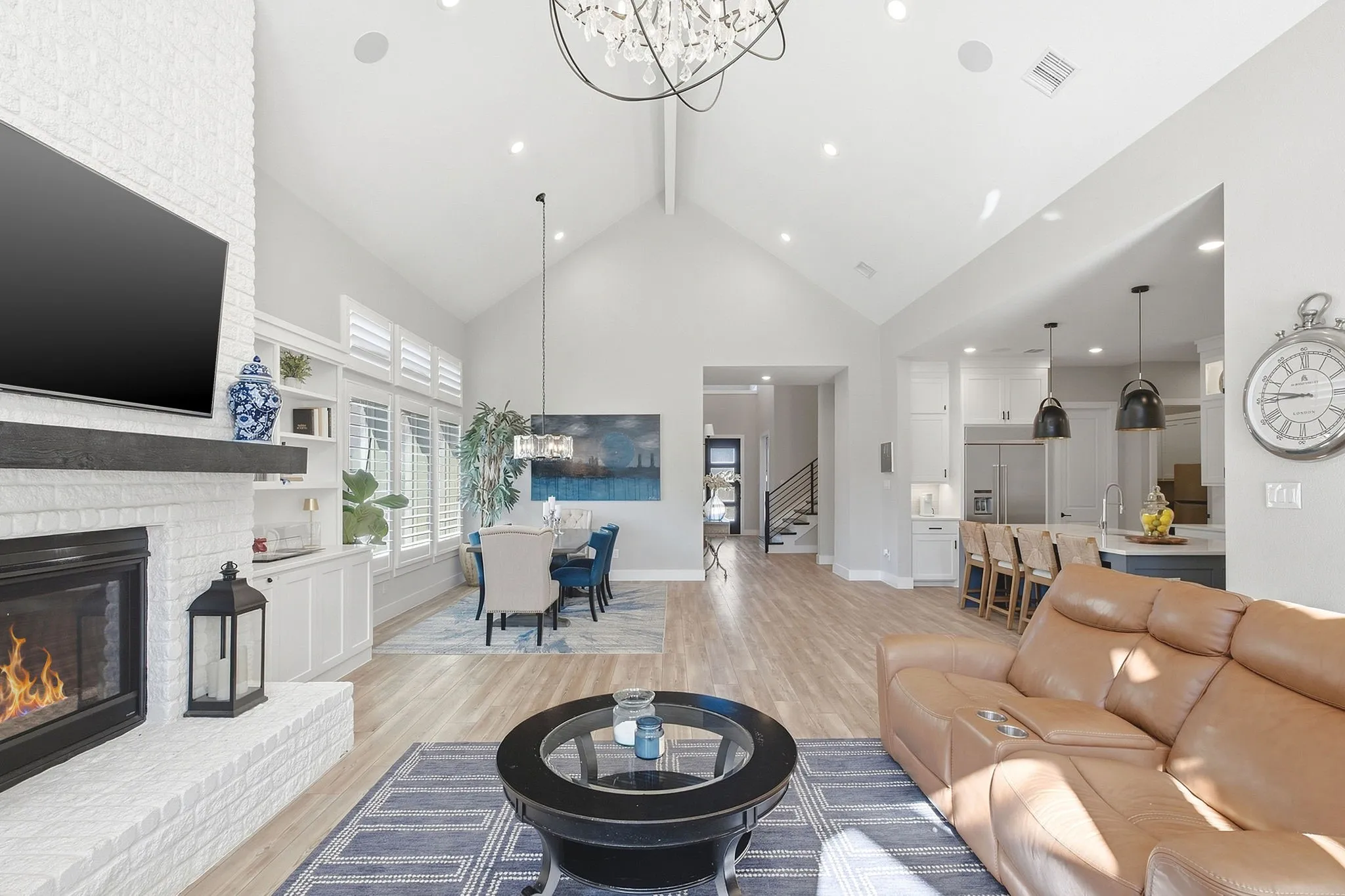 Gourmet kitchen with a large center island, white cabinetry, and stainless steel appliances