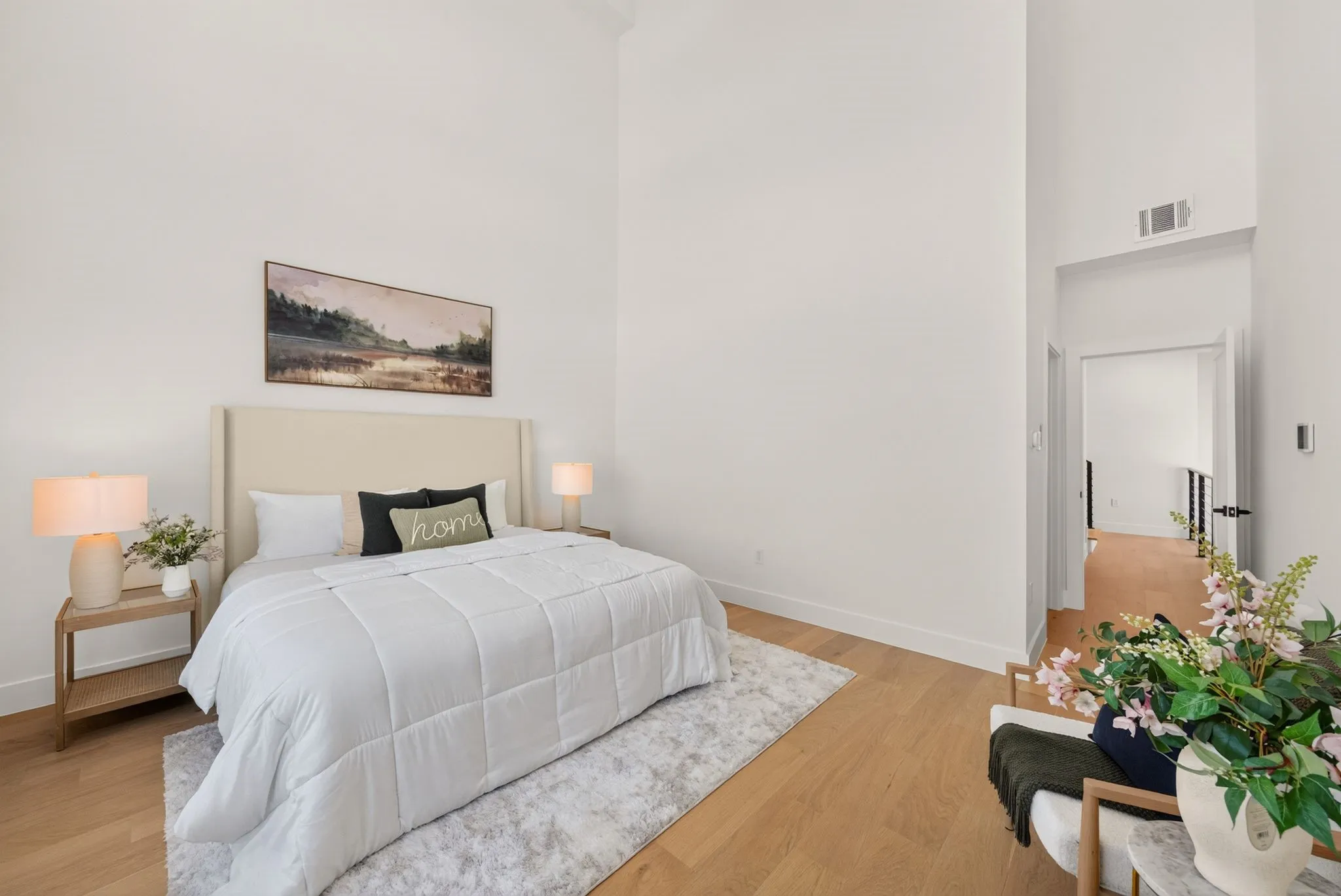 Wood-finish flooring with a neutral area rug