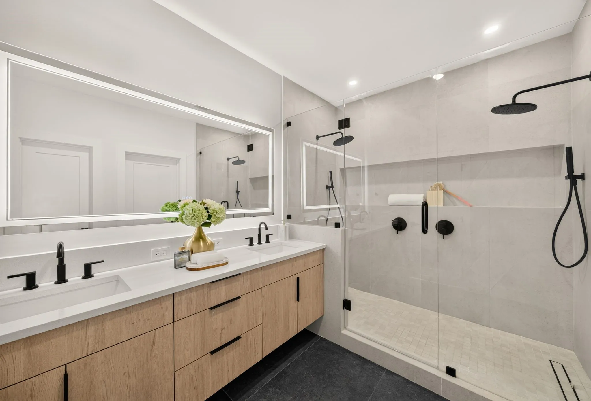 Dual vanity with white countertops and wood-finish cabinetry