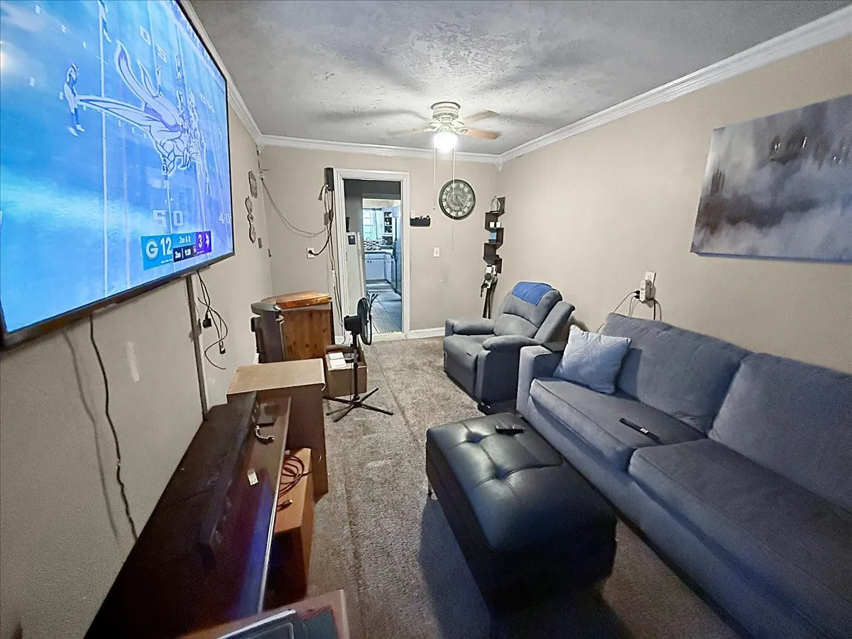 Broad perspective of the living room detailing smooth transitions between main home gathering spaces.