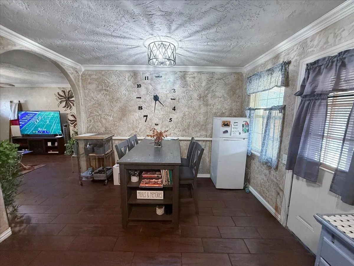 Dedicated dining area highlighting modern lighting fixture, wood floors, and open floor plan flow.