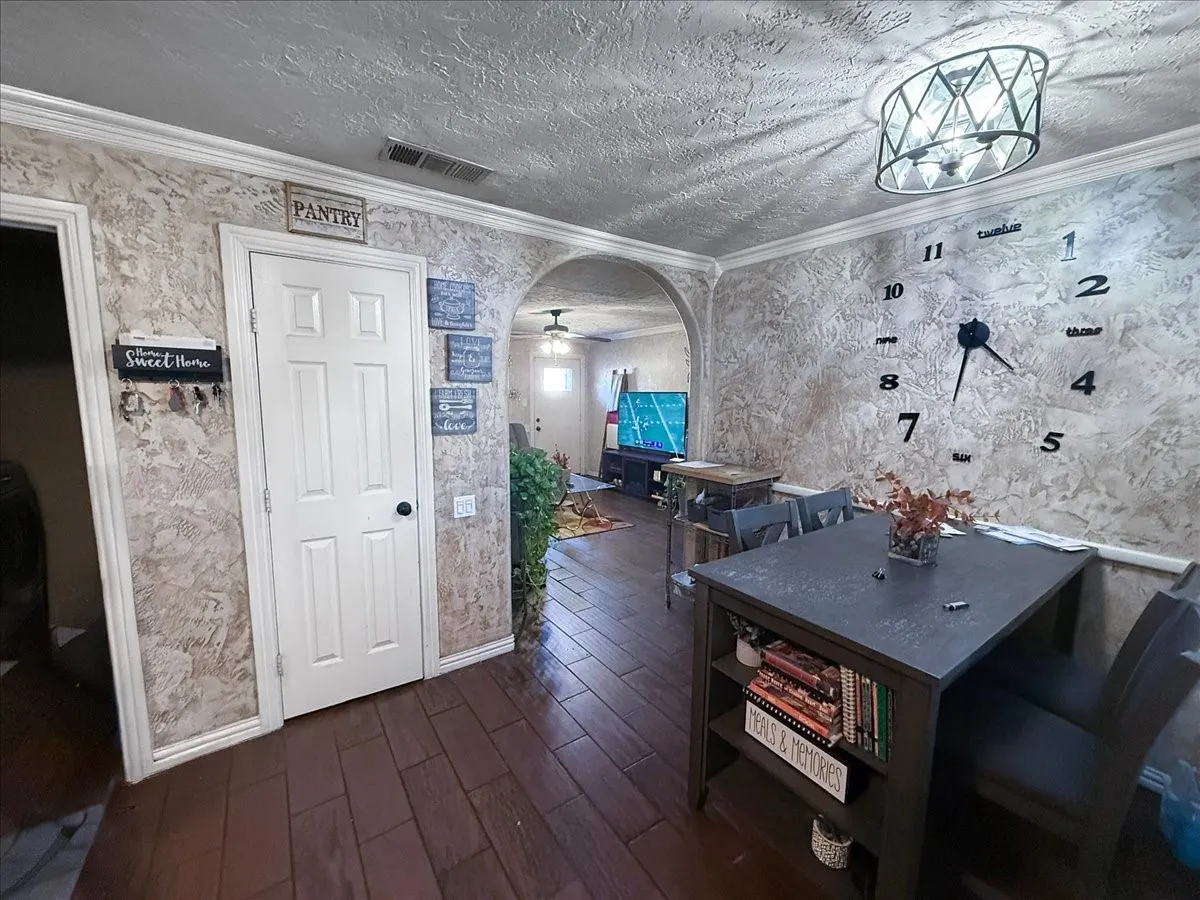 Dining space perspective showing stone accent wall detail and transition into interior hallways.