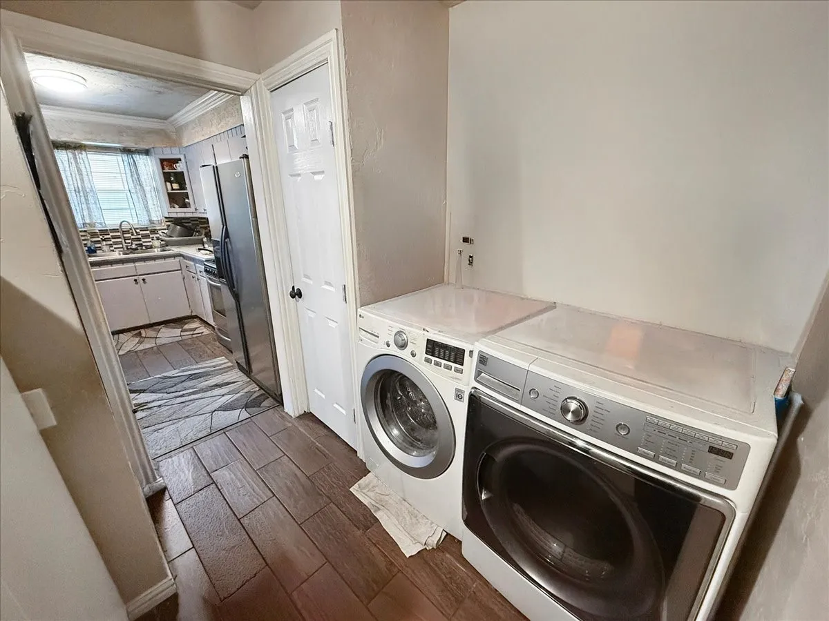 Dedicated utility and laundry area featuring front-load washer and dryer set with workspace counter.