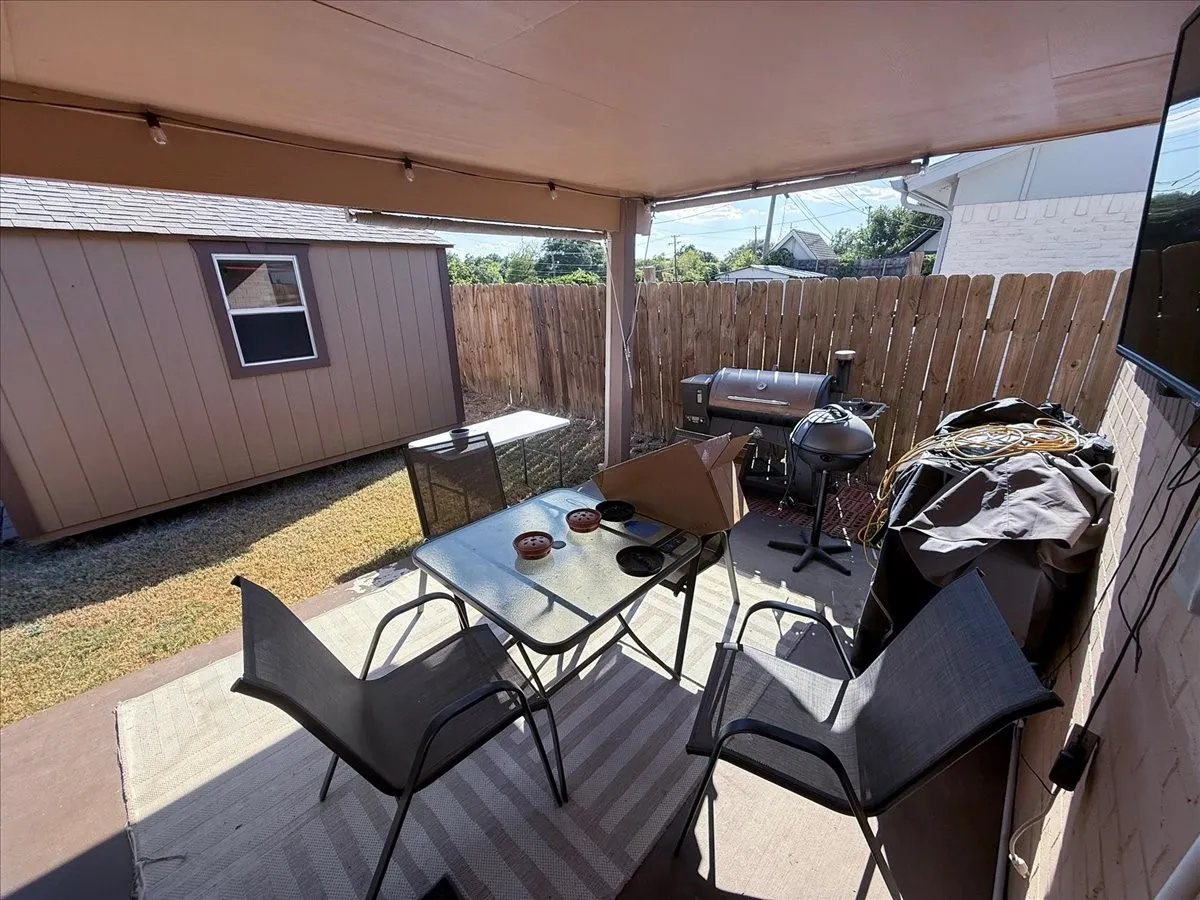 Covered outdoor patio deck providing shaded lounge seating and outdoor dining space.