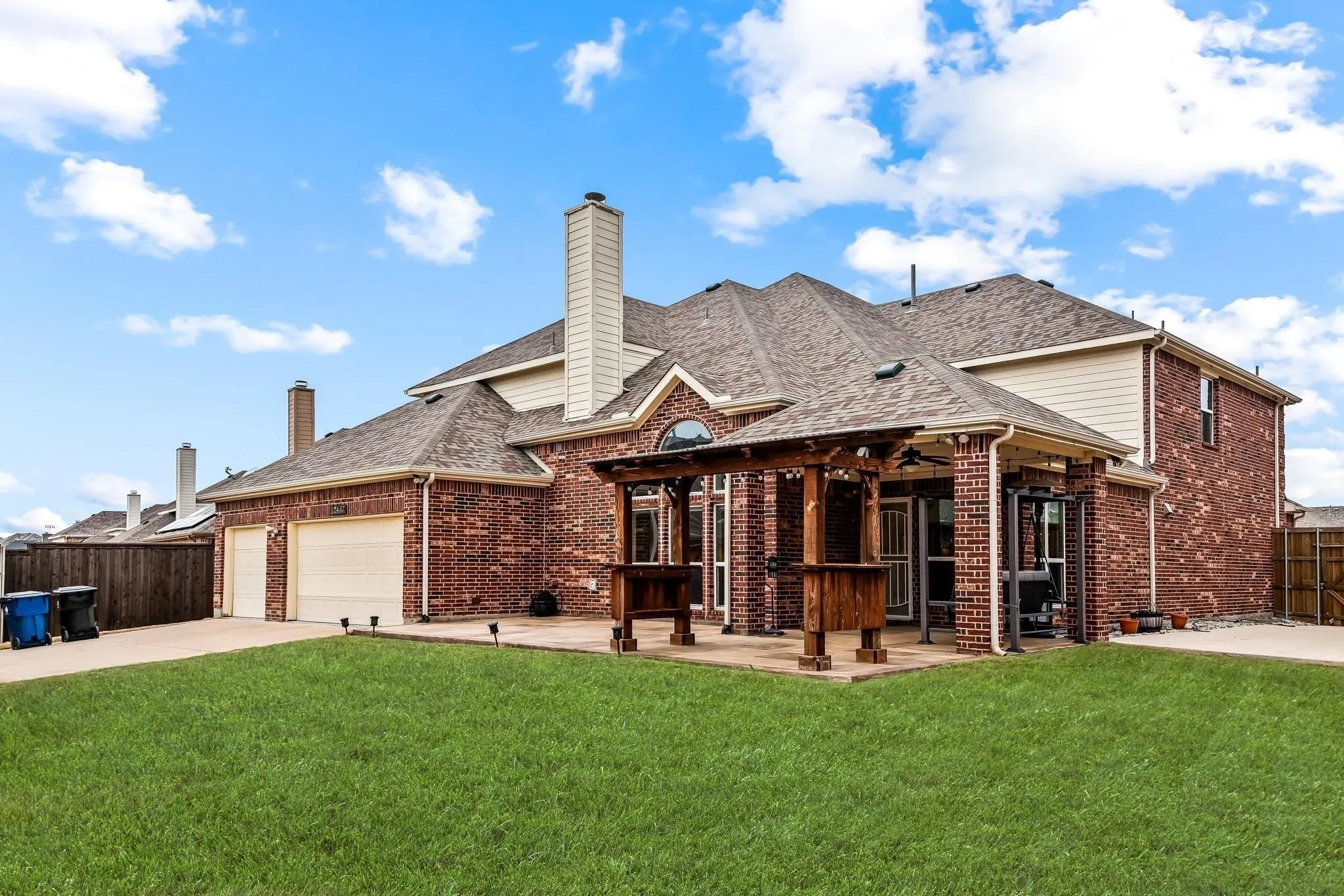 Brick exterior with a covered patio and pergola