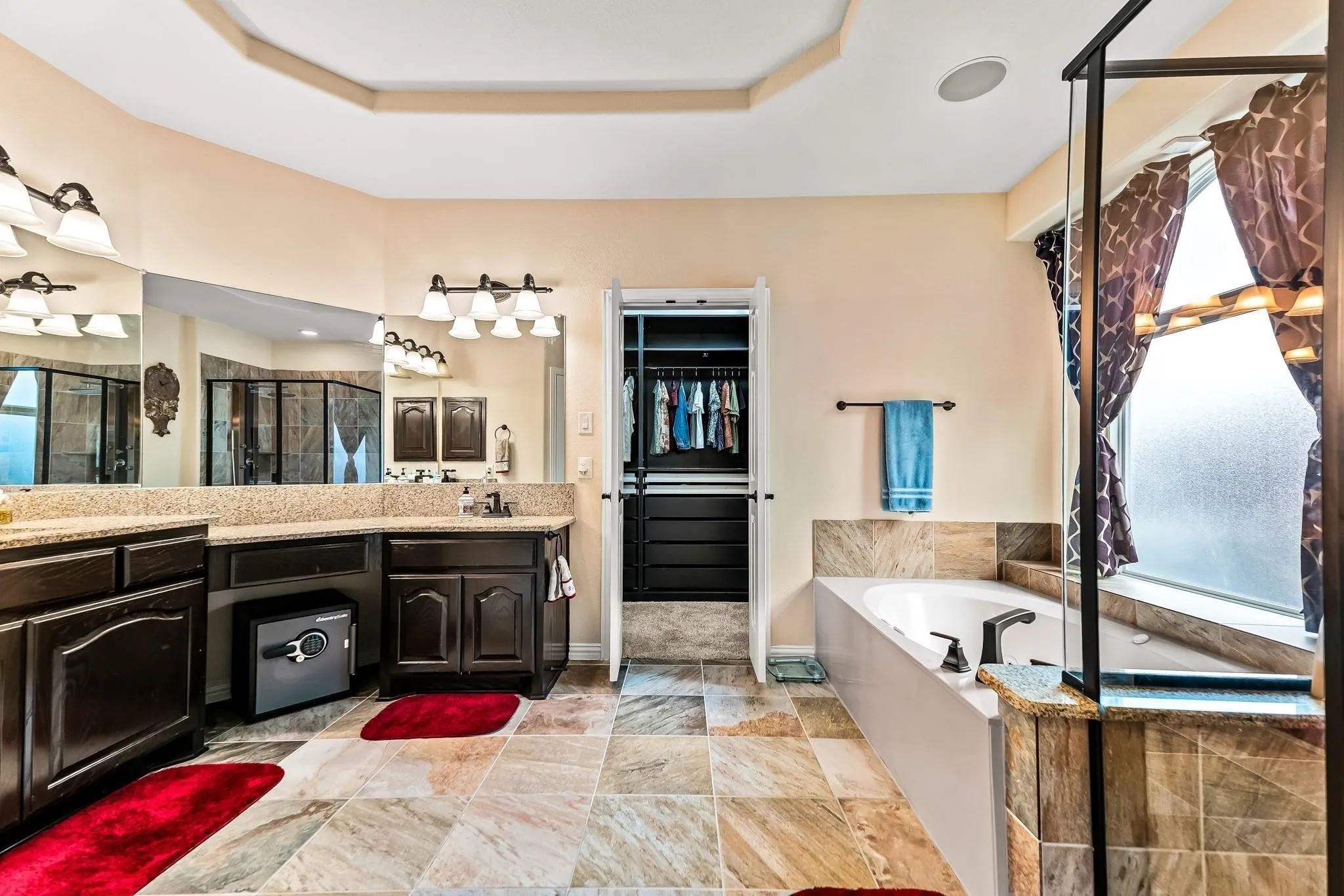 Dual vanity with dark wood cabinetry and light-colored countertops