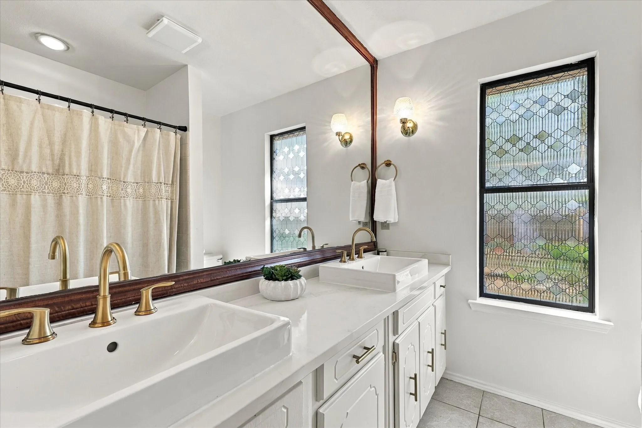 Dual vessel sinks with gold-toned fixtures