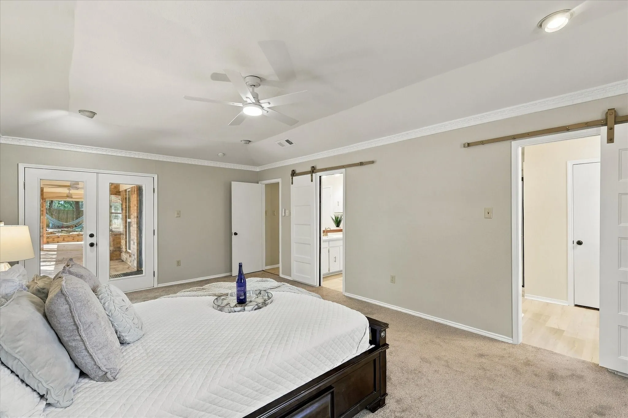 White french doors, ceiling fan, recessed lighting, crown molding, and two barn doors