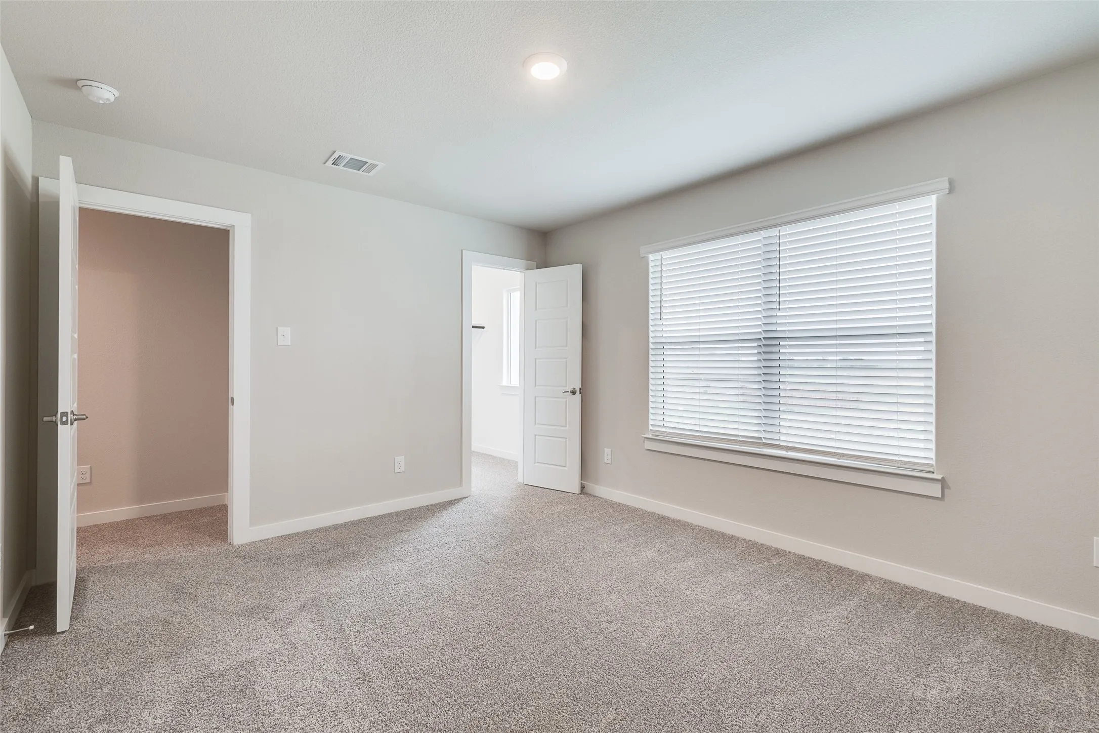 Carpeted flooring with light neutral walls