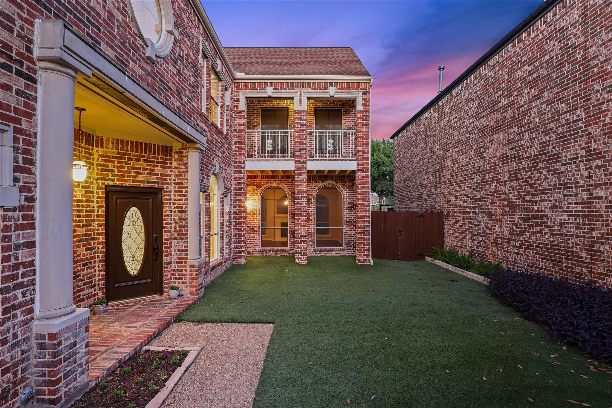 The front courtyard is turfed and gated.