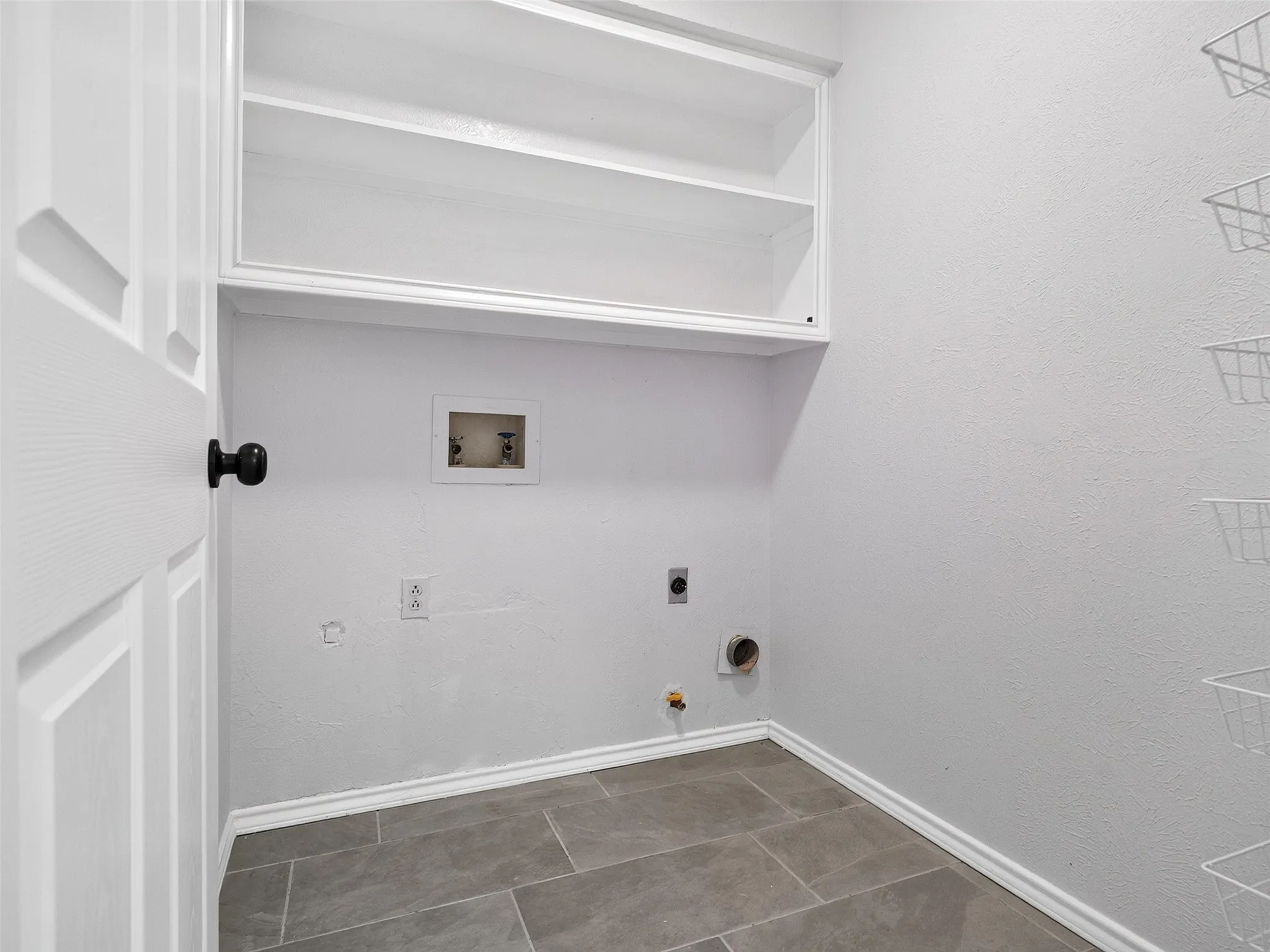 White built-in cabinetry provides storage in this utility space