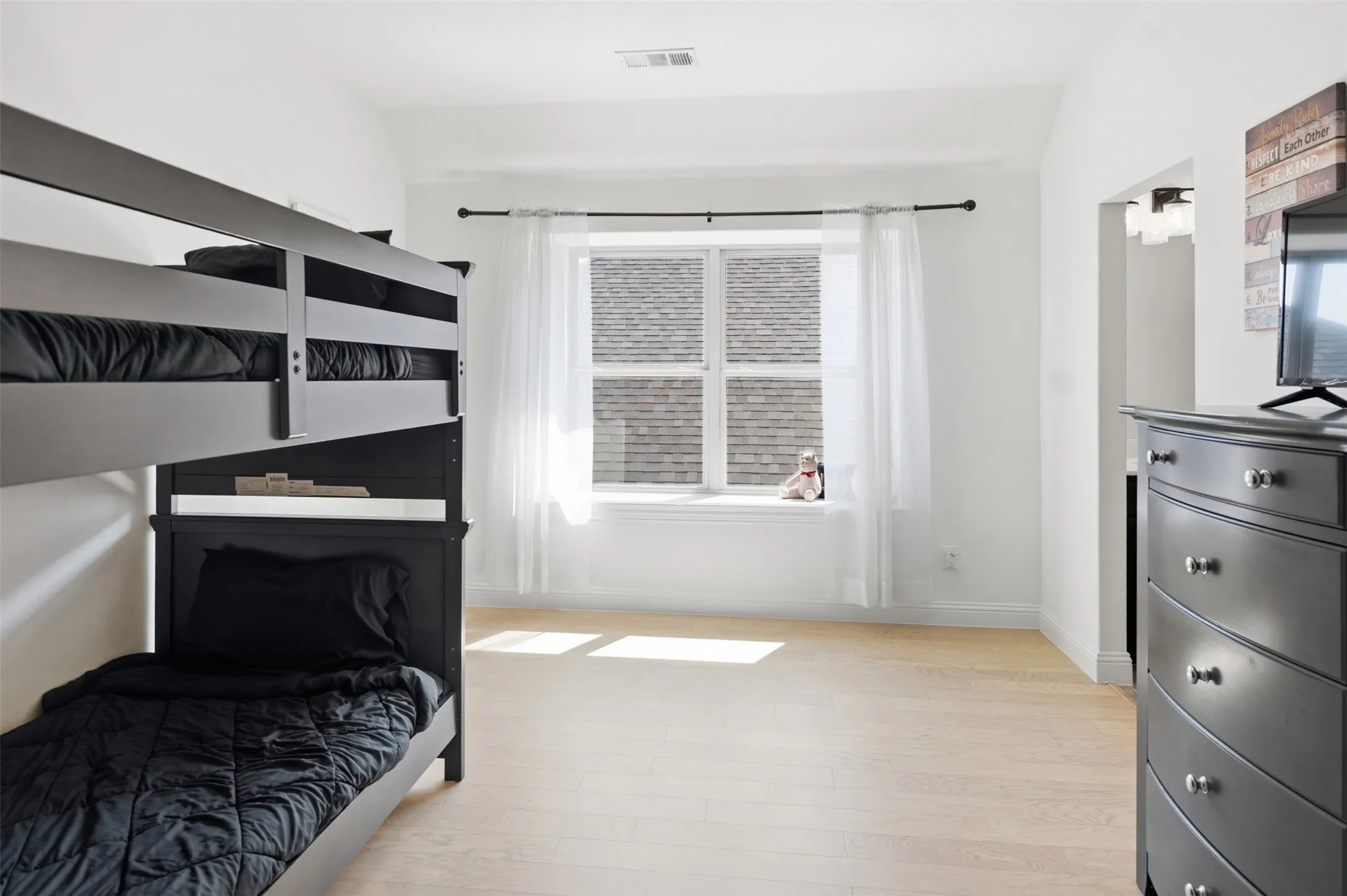 Bedroom 4 - Light wood-finish flooring with crisp white walls