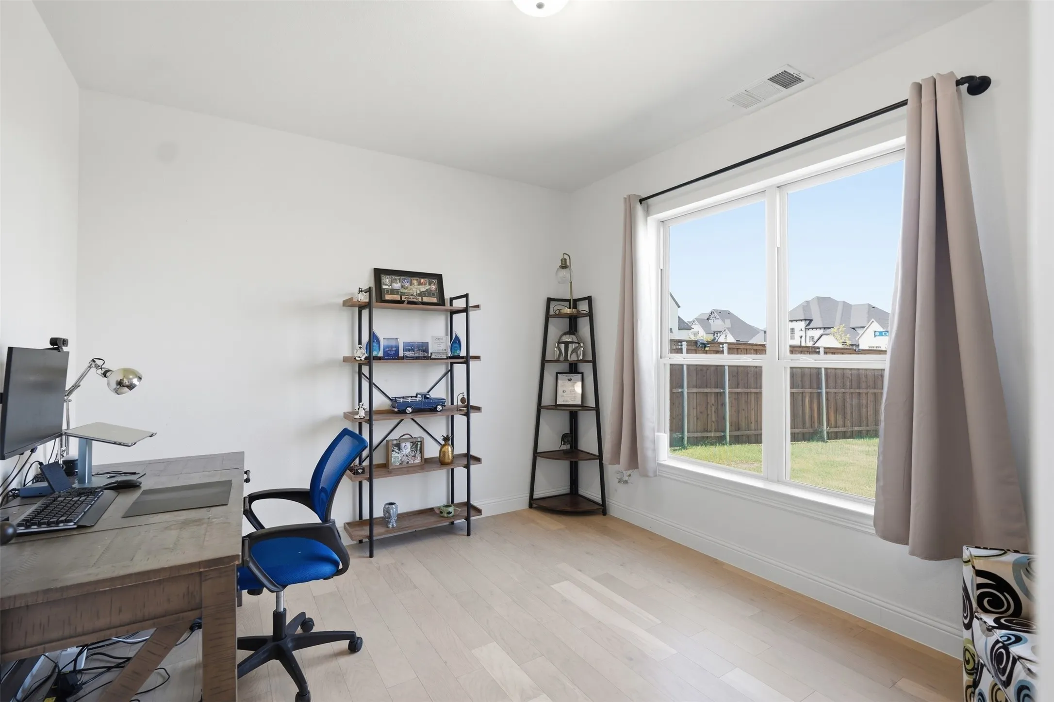 Bright room featuring wood-finish flooring and a large window