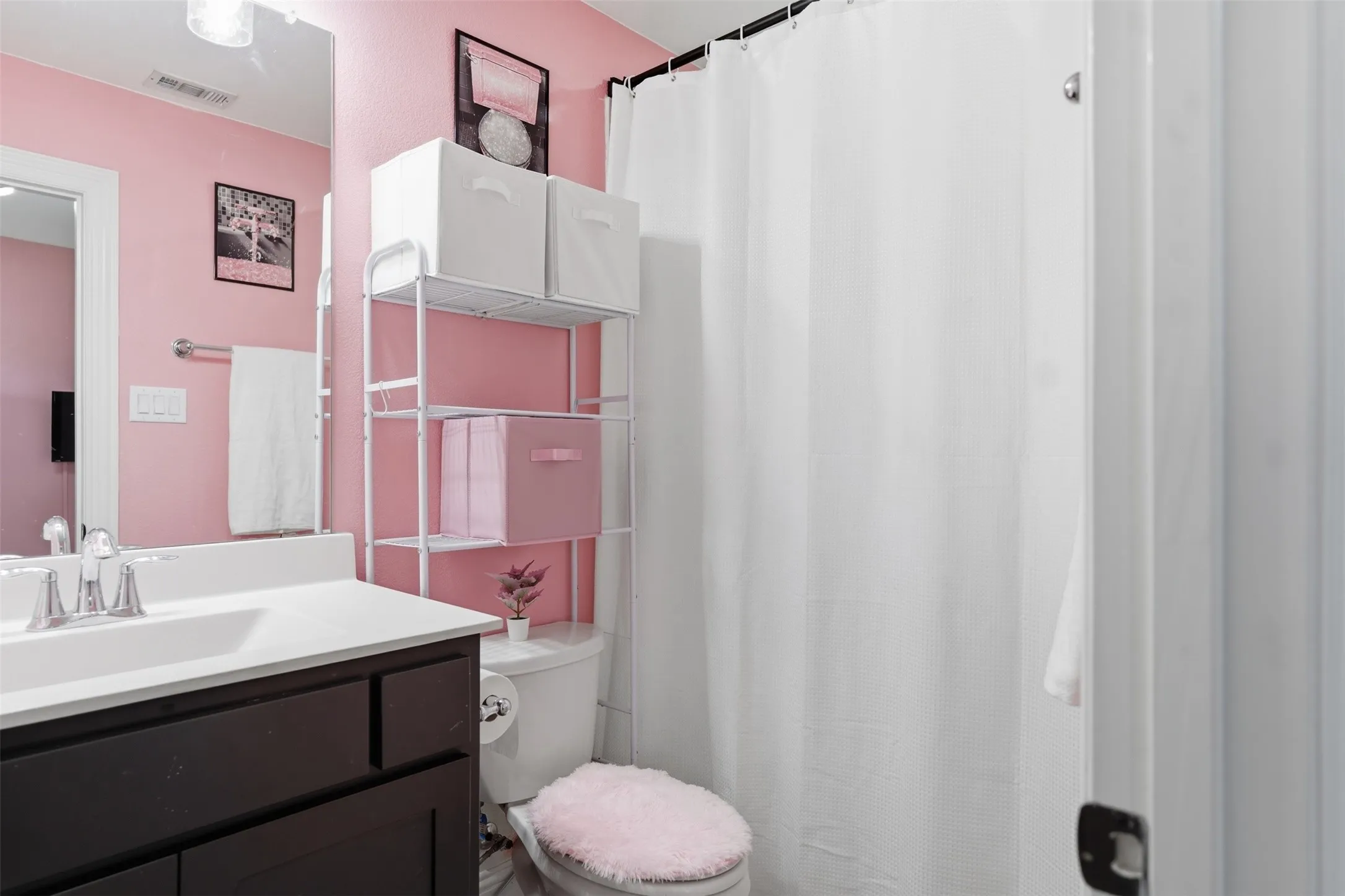 5 bathroom - ensuite Bathroom featuring a dark wood-finish vanity, white countertop, and a vanity mirror