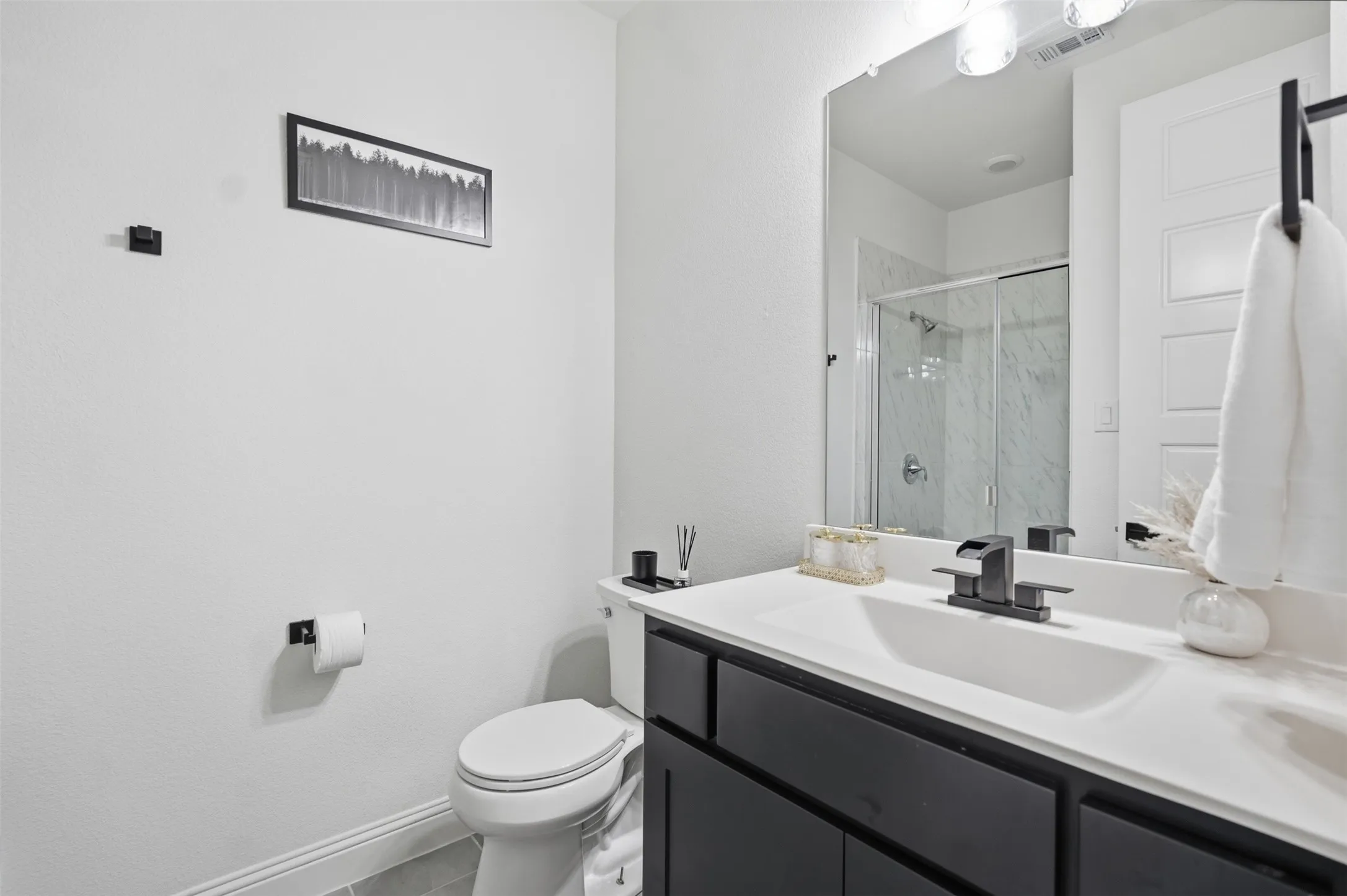 Downstairs Bathroom with shower - Vanity with built-in rectangular sink, matte black faucet, and white countertop