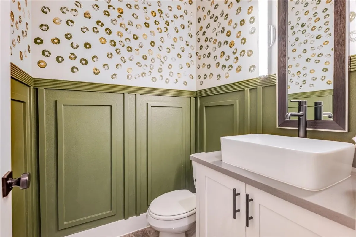 Wainscoting with decorative paneling and a patterned accent wall