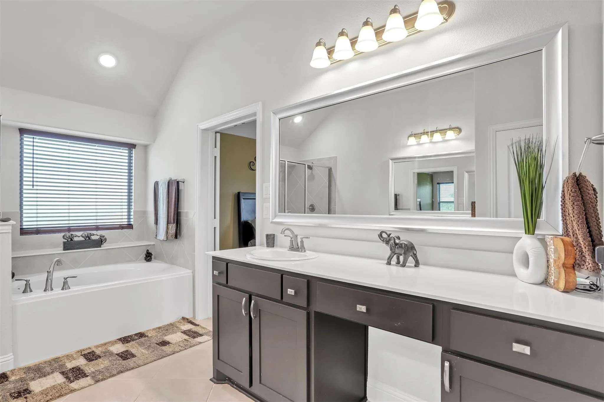 White soaking tub with deck-mounted fixtures