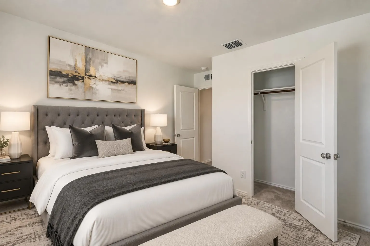 White walls, recessed lighting, and a built-in closet with double doors