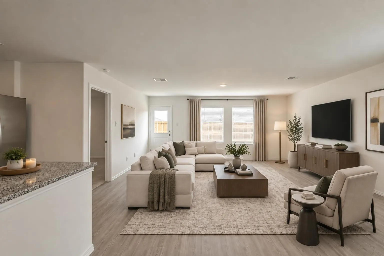 Open-concept living space featuring wood-finish flooring, recessed lighting, and ample natural light from multiple windows