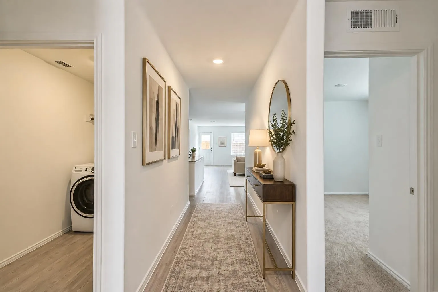 Hallway featuring recessed lighting, wood-finish flooring, and a dedicated laundry area with a washer