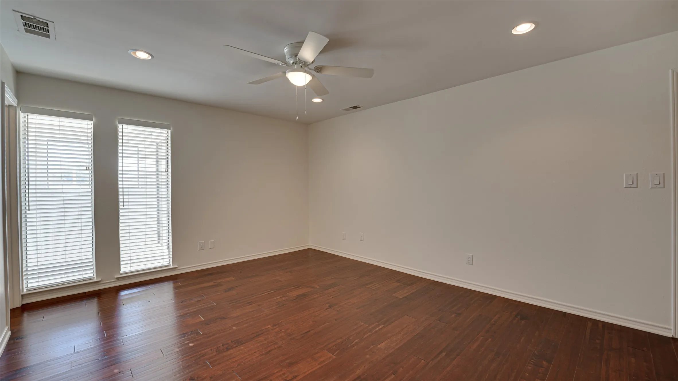 Bedroom with ceiling fan and hardwood / wood-style flooring