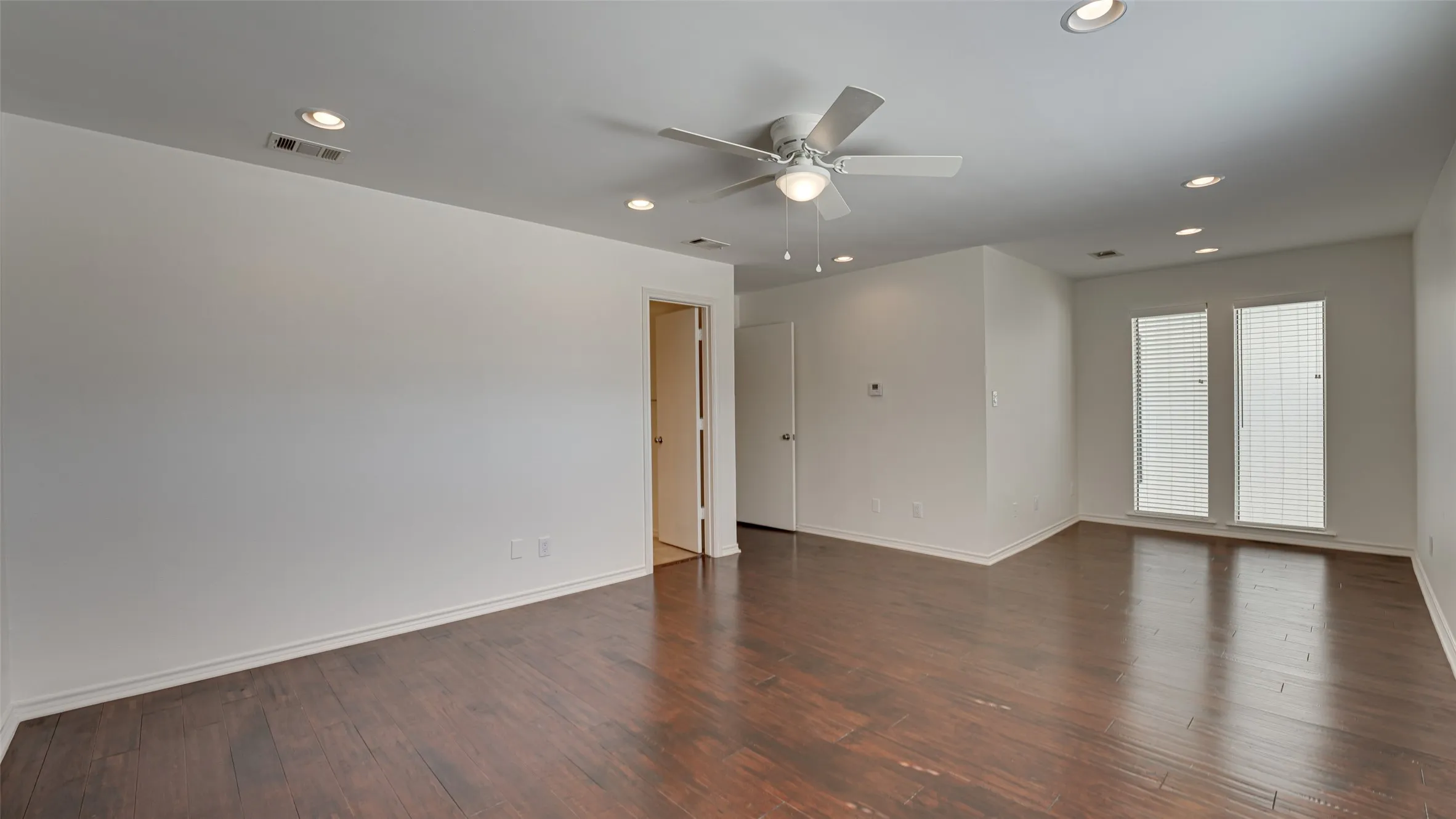 Bedroom featuring wood-type flooring and ceiling fan