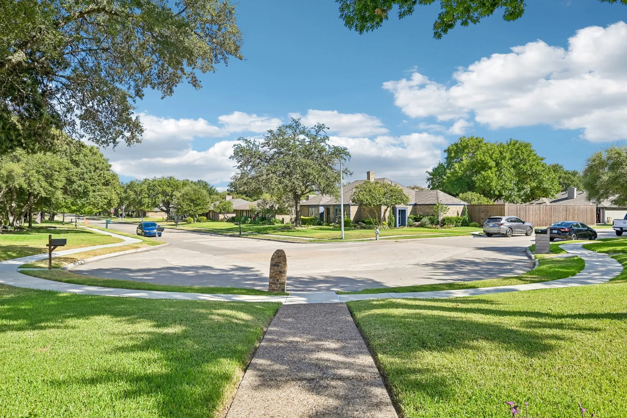 Landscaped front yard with mature trees