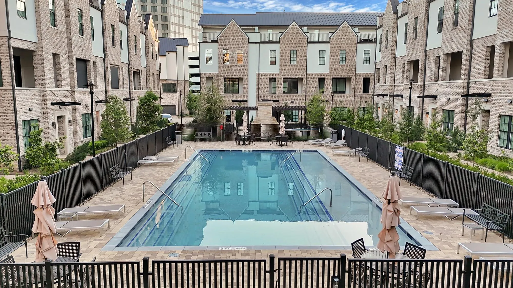 Central swimming pool surrounded by paver decking