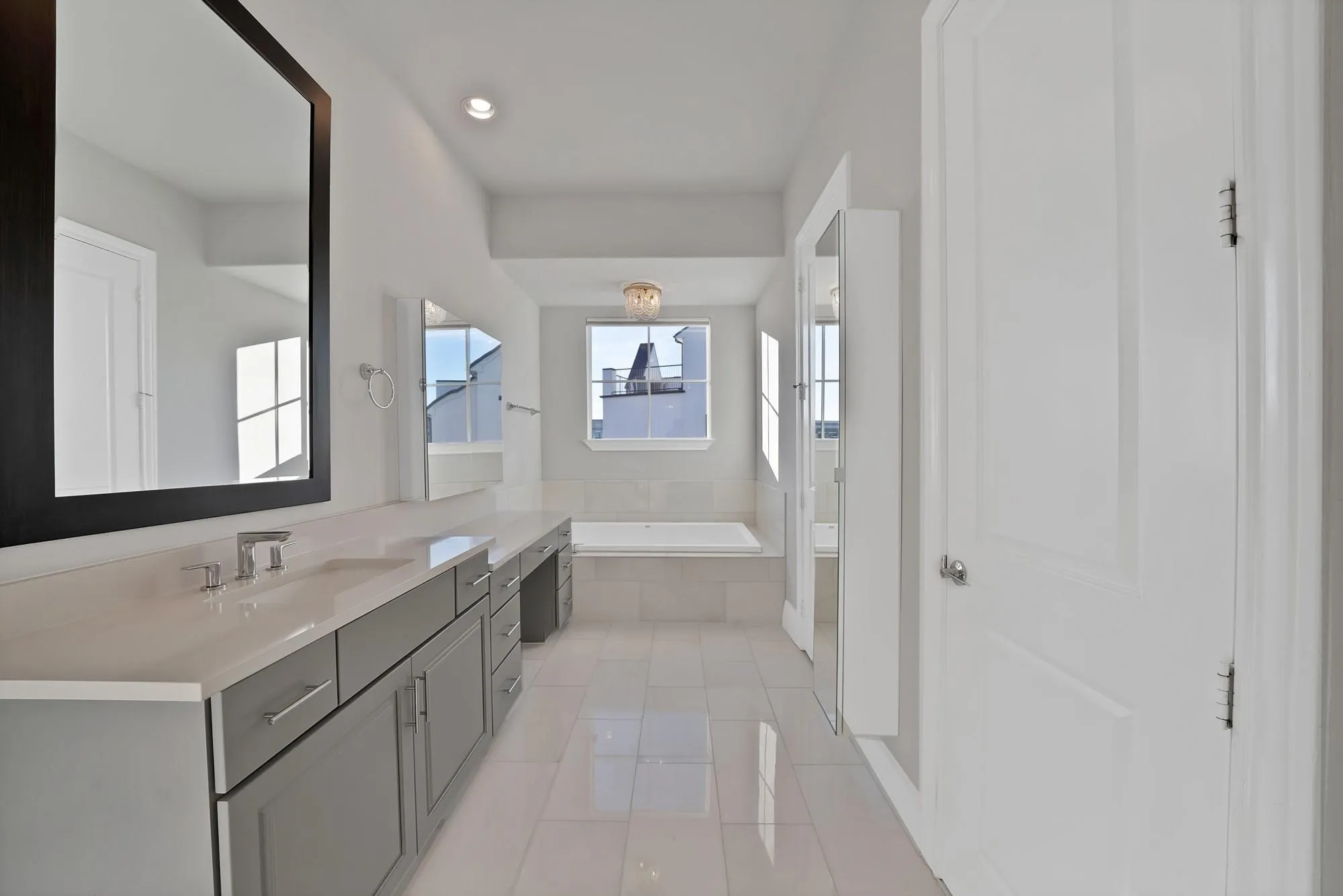 Dual vanity with modern gray cabinetry and light-toned countertops