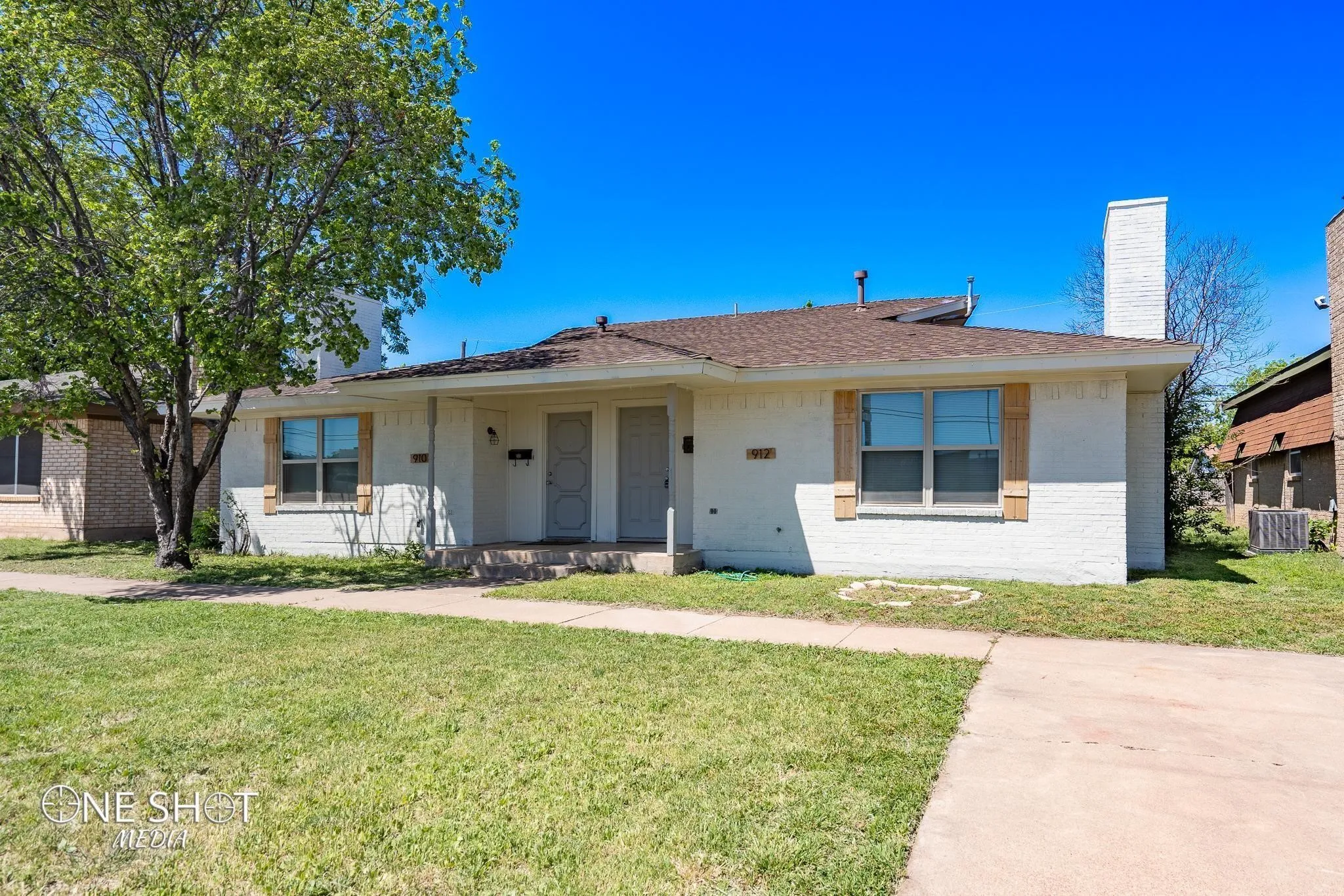 View of front of home featuring a front yard and central air condition unit