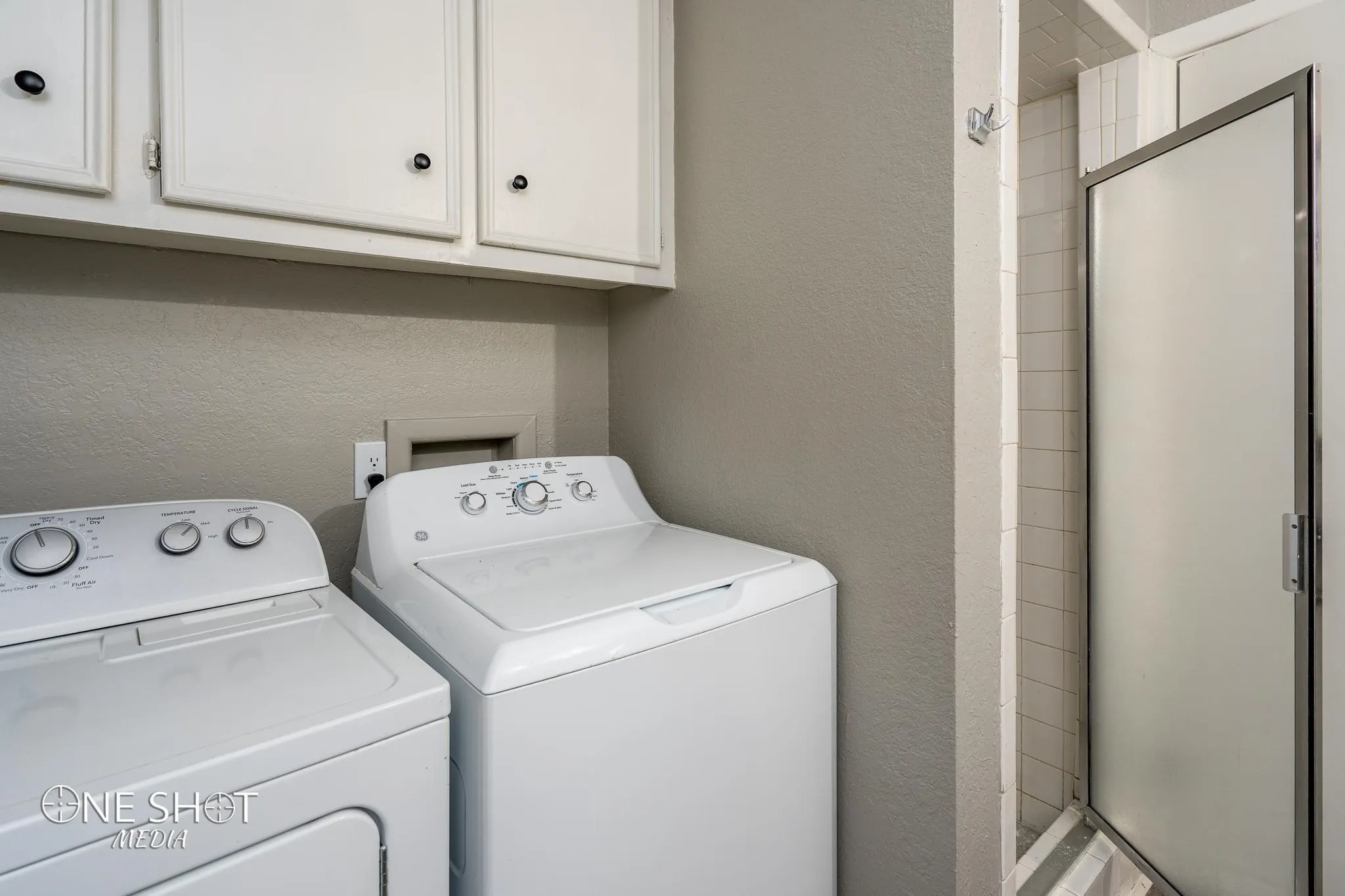 Washroom featuring washing machine and dryer