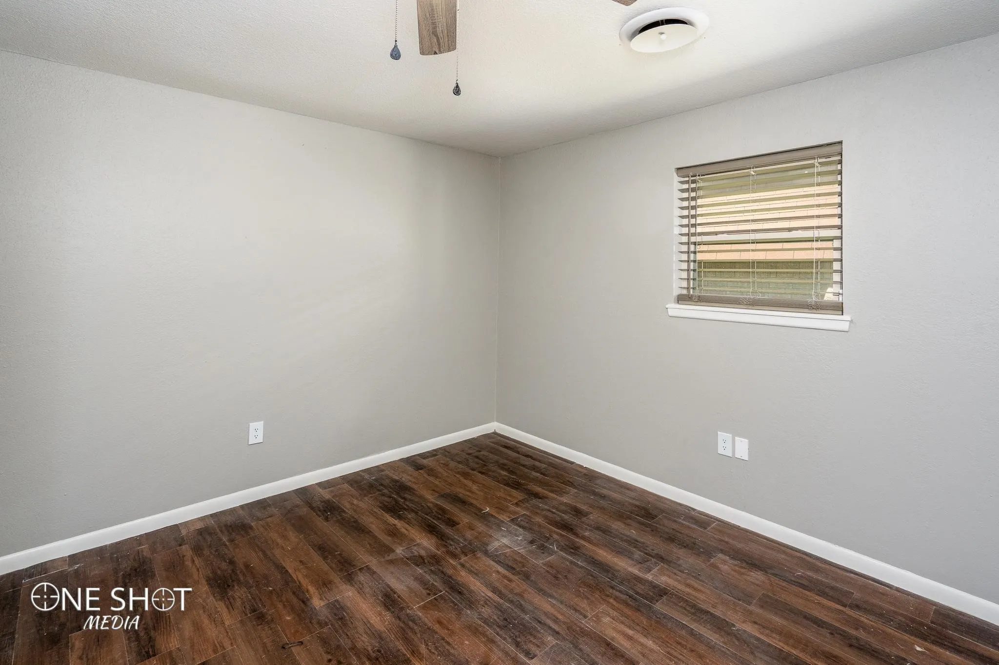 Empty room featuring dark hardwood / wood-style flooring
