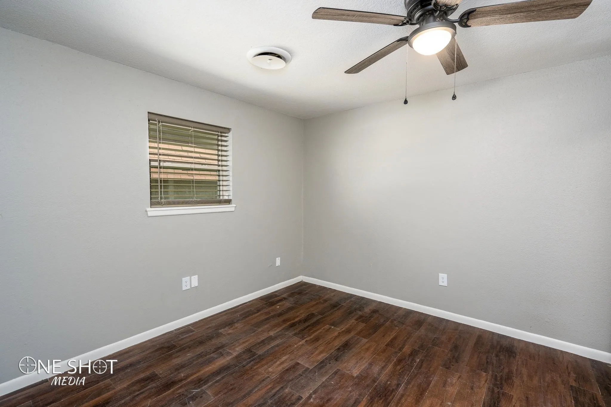 Spare room with ceiling fan and dark hardwood / wood-style flooring