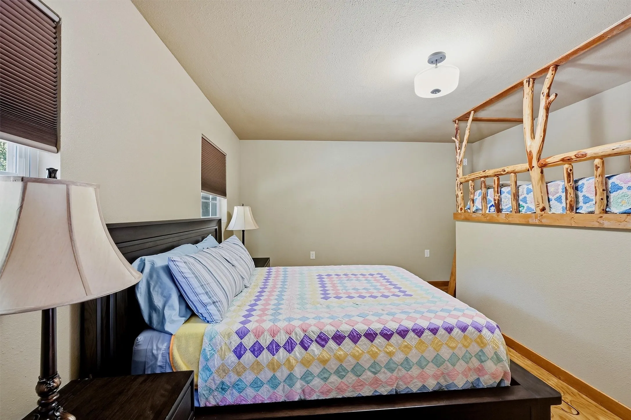 upstairs bedroom features a twin bunk and a Queen size bed