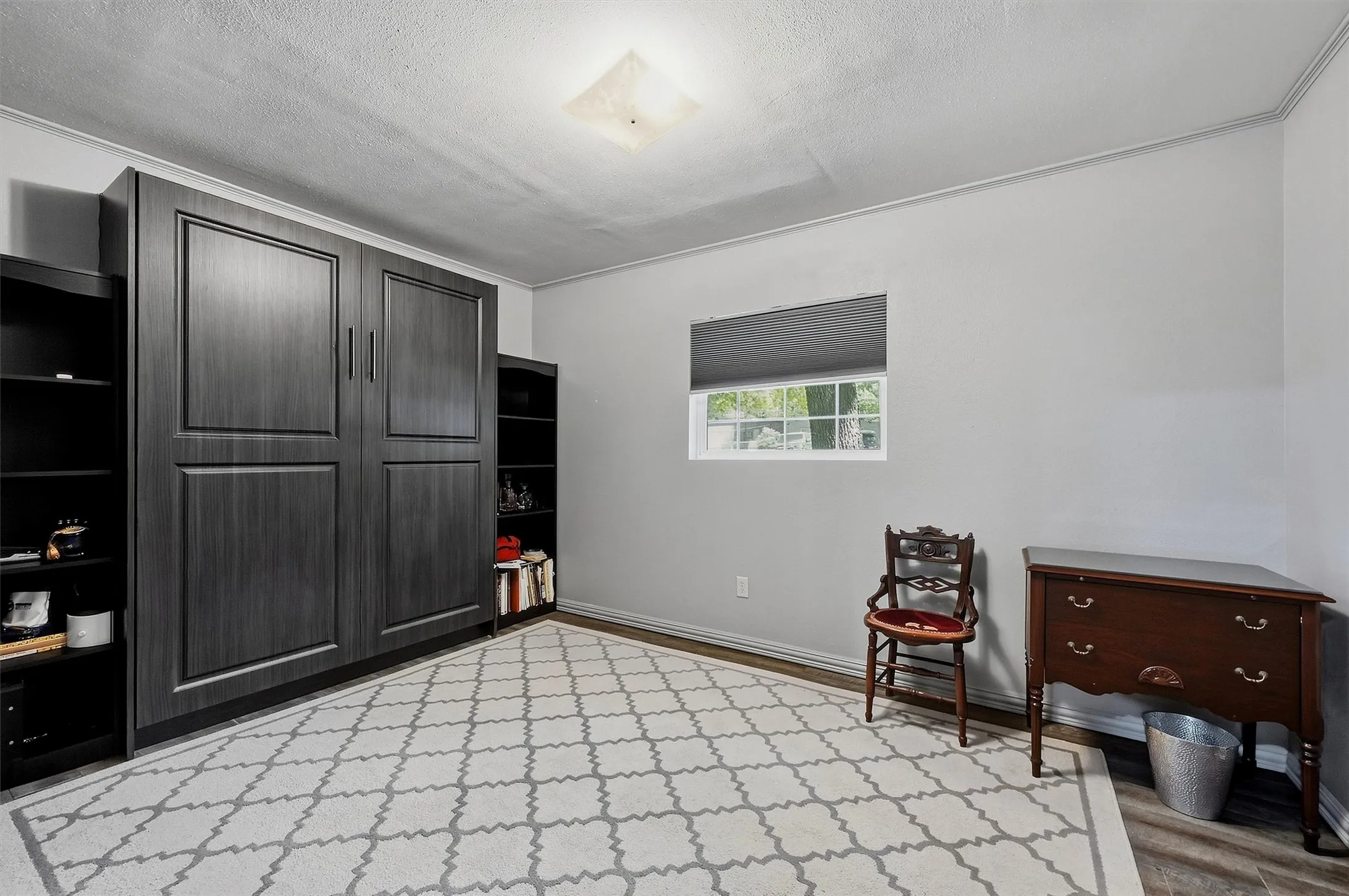 Queen size Murphy bed stays with property to make this a versatile room for office or a guest bedroom.