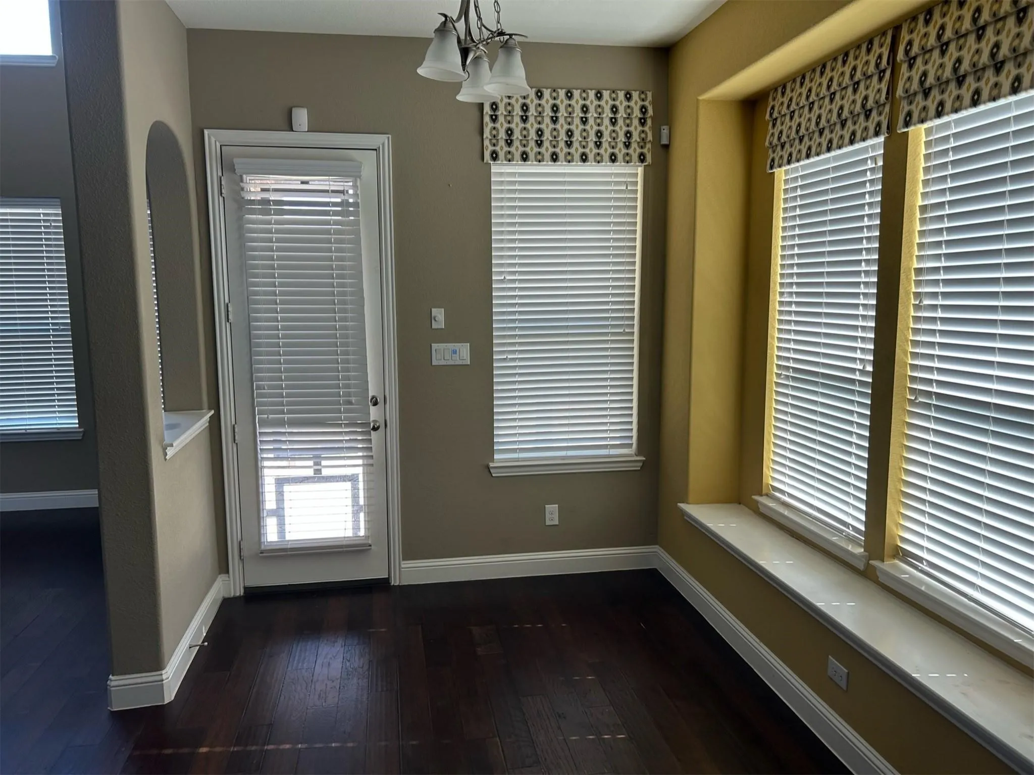 Entryway featuring wood finished floors and a chandelier
