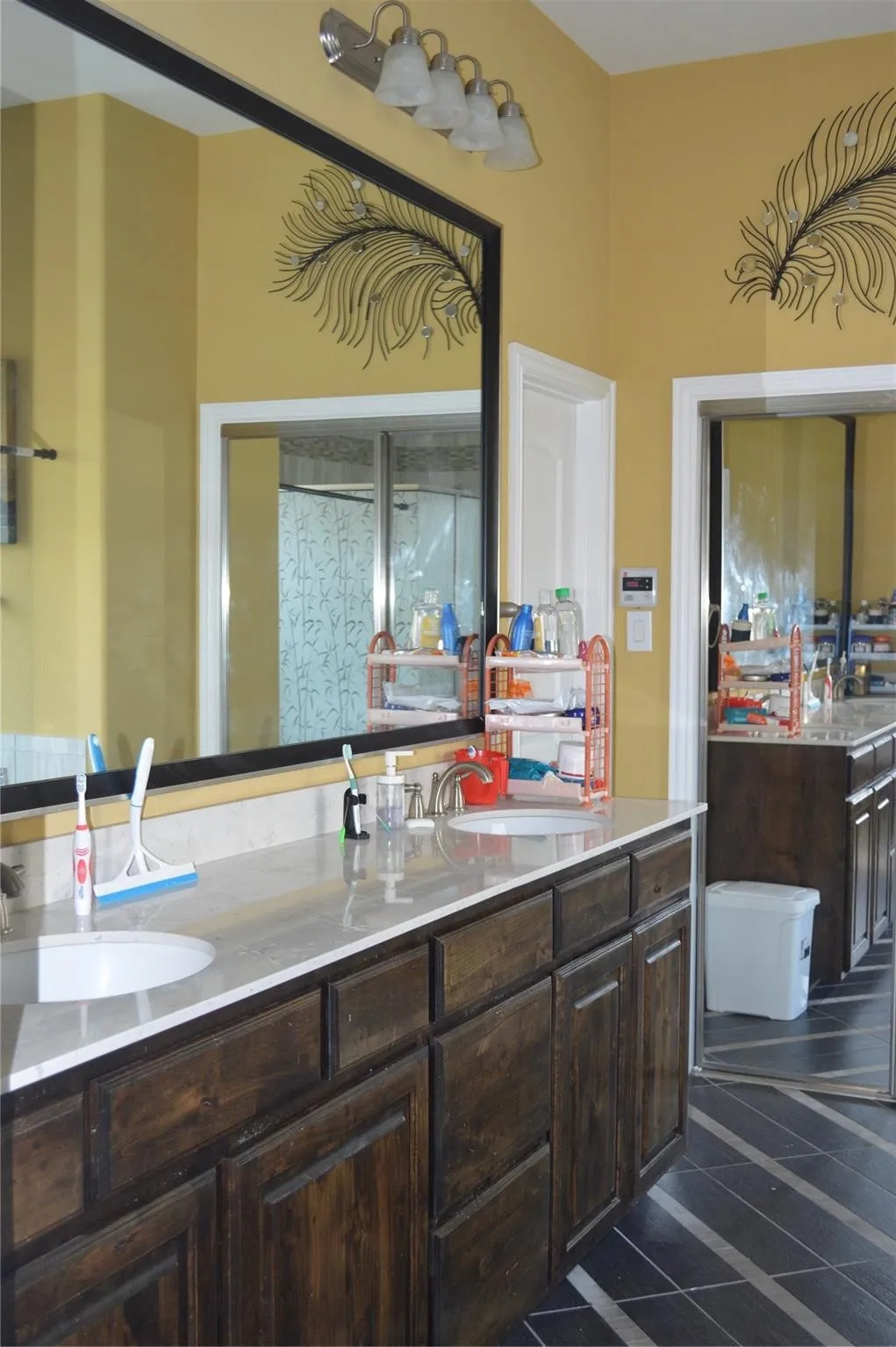Full bathroom featuring double vanity and tile patterned flooring