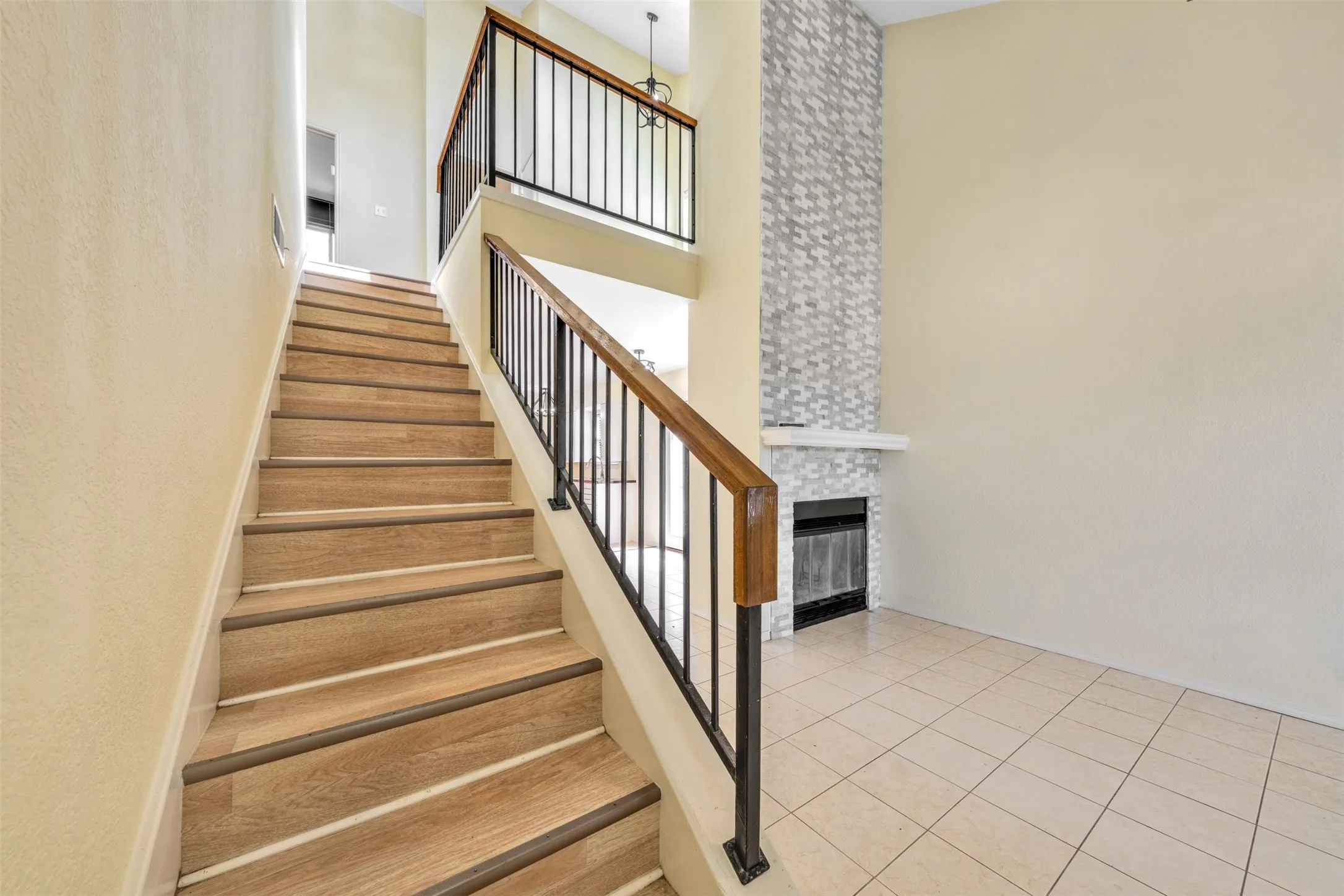 Wood-finish stairs with wrought iron and wood handrails