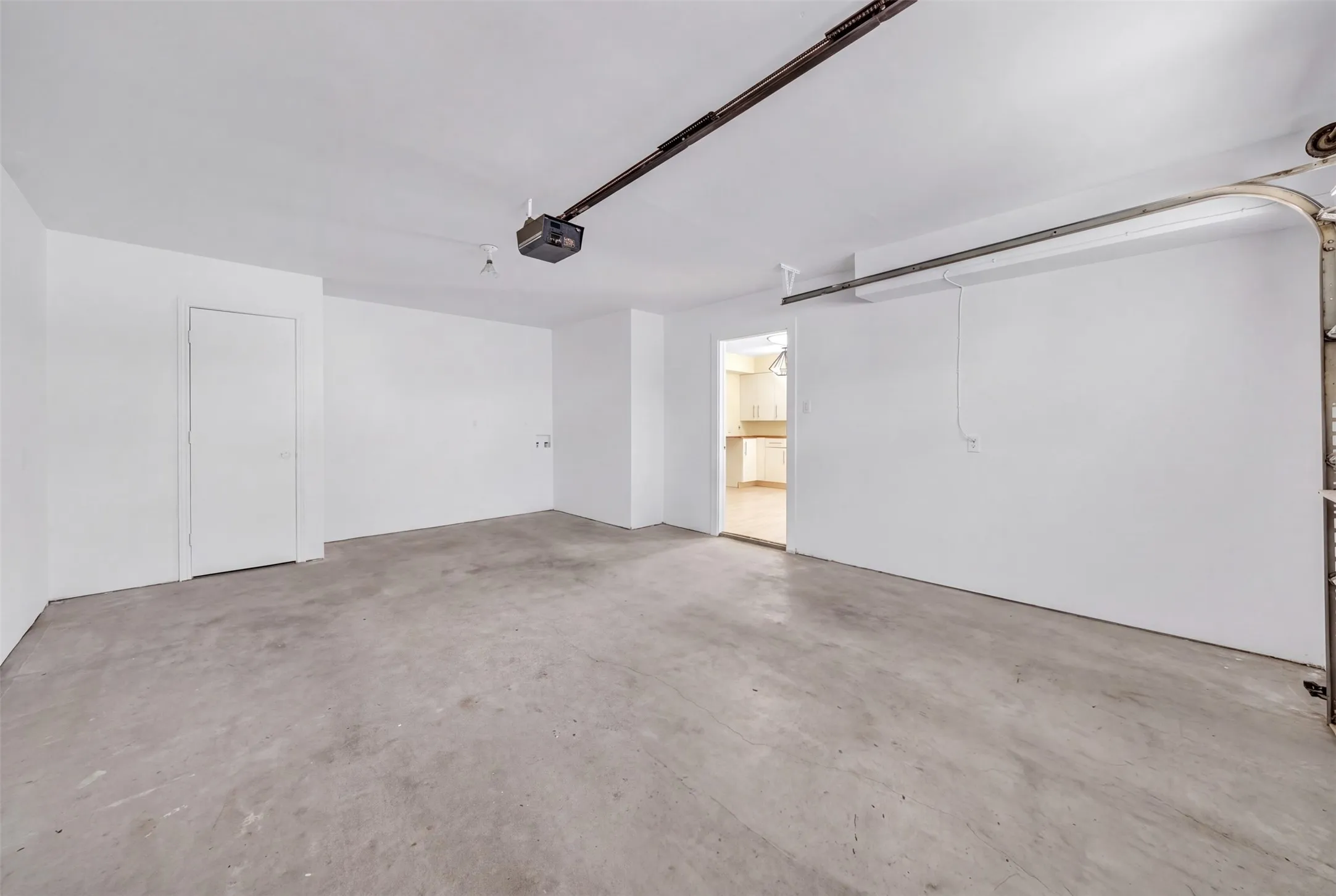Spacious garage with concrete flooring and white walls